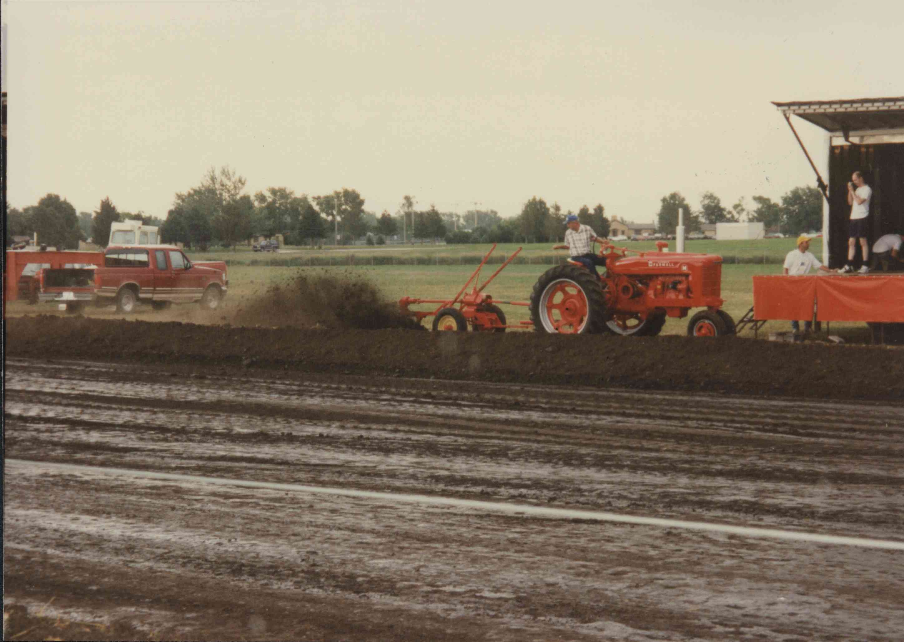 Red tractor and plow being driven at the Plymouth County Fair in July 1996.