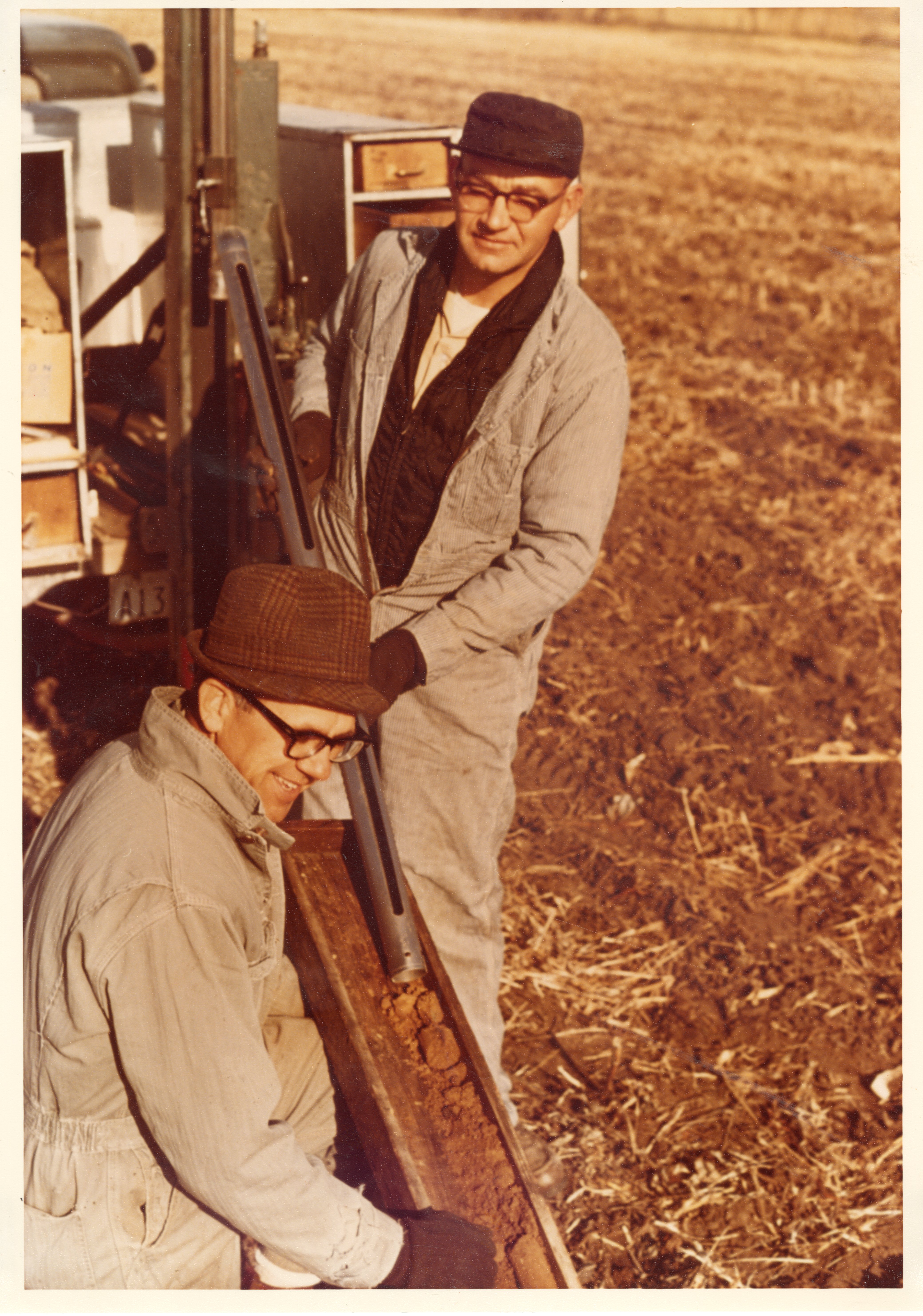 1970s Two men check dirt samples