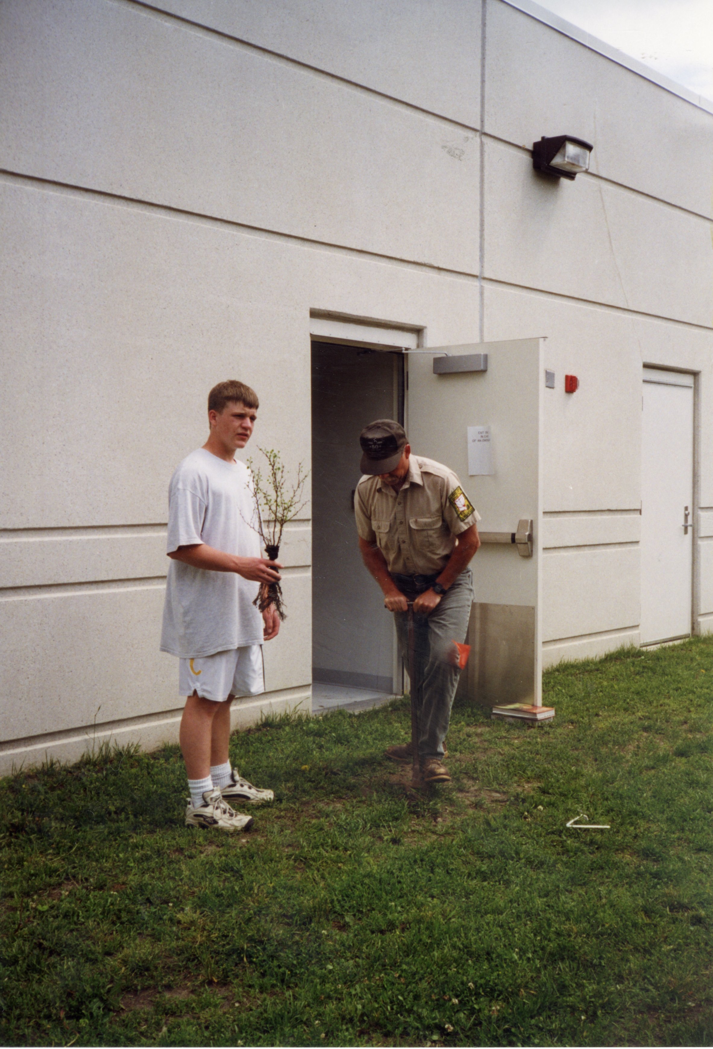1999 Commissioner Jeff Bergman and student Kyle Law plant a tree