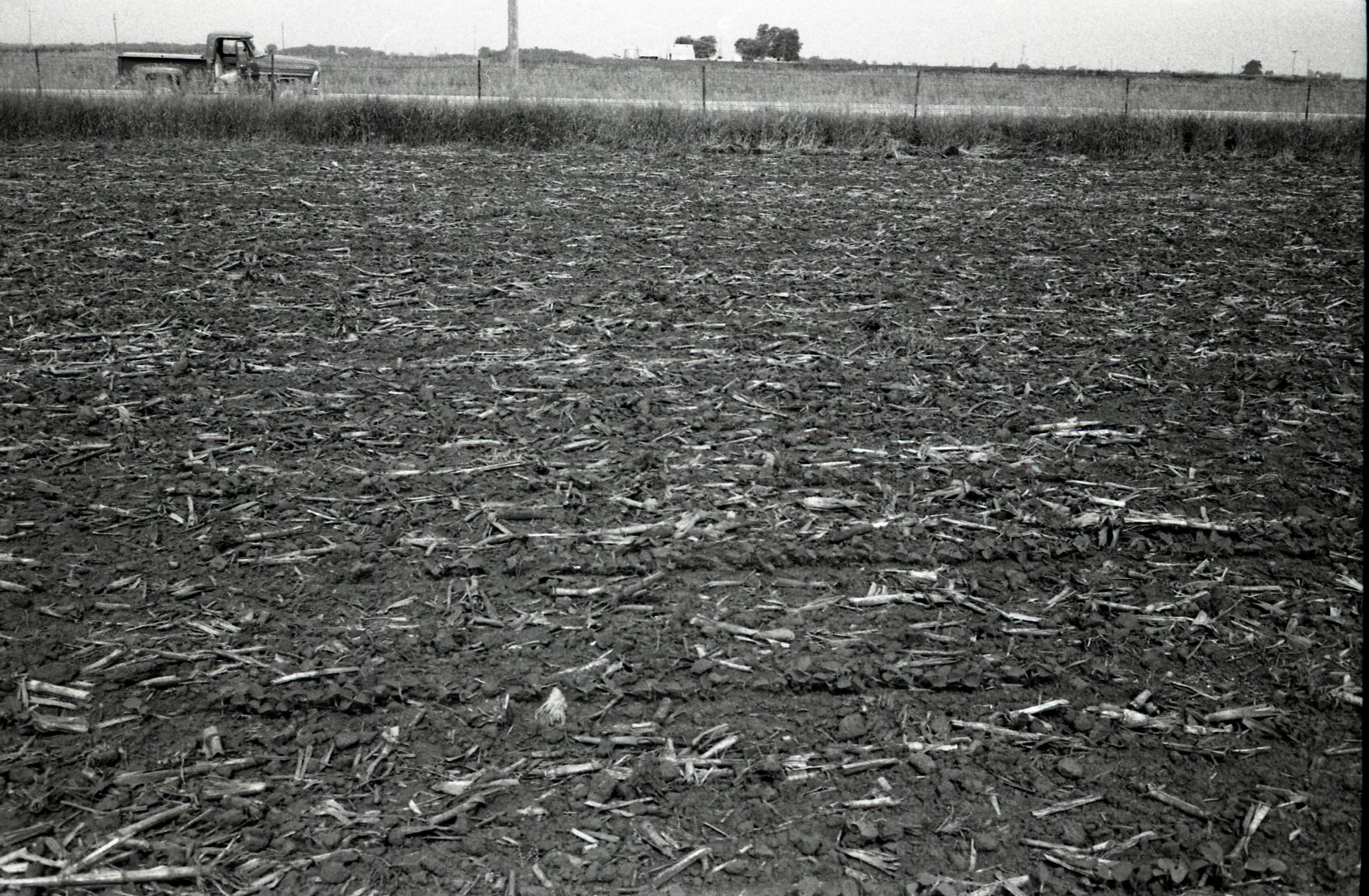 Truck parked by no-till field