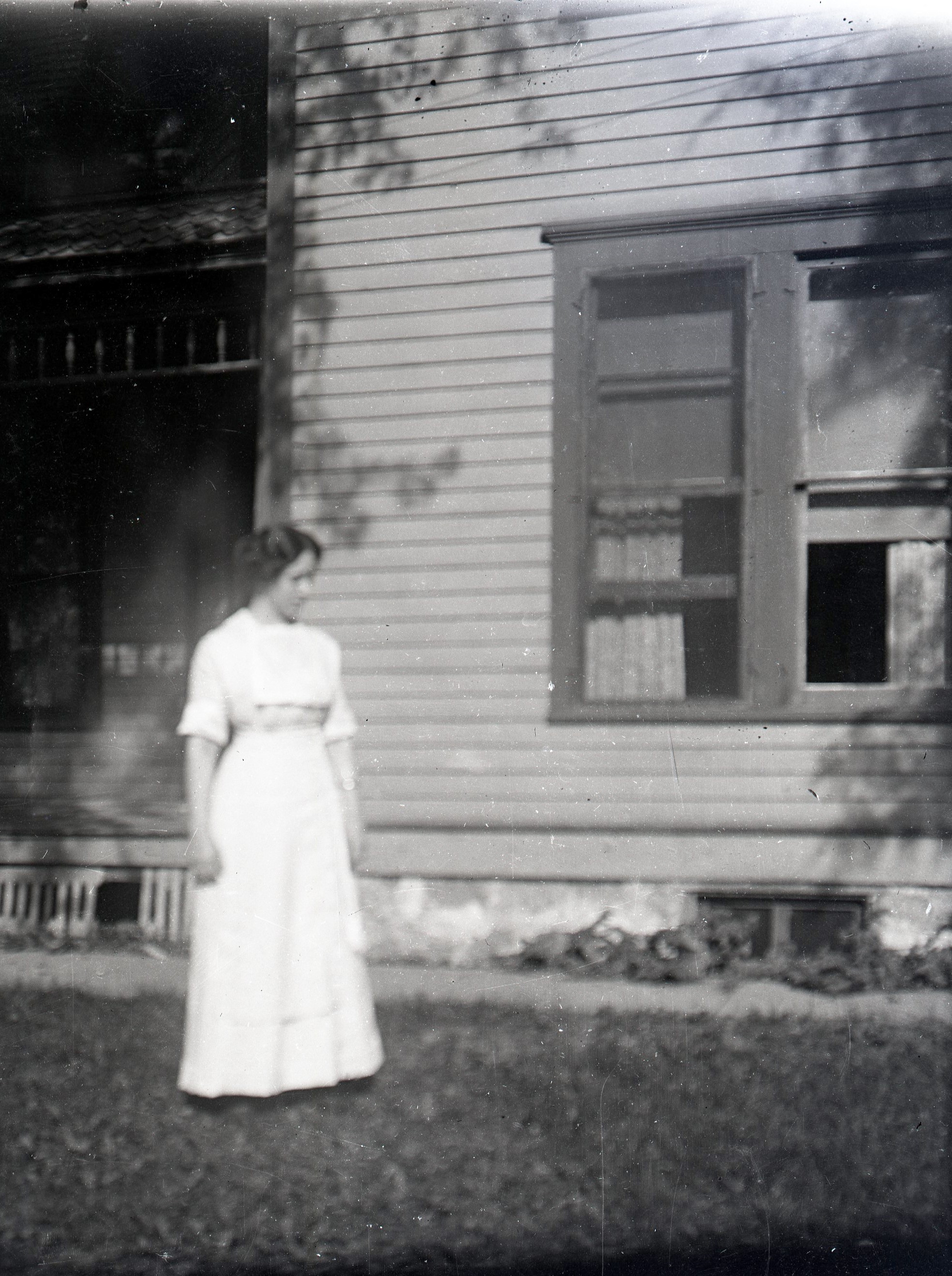 Woman by window on lawn