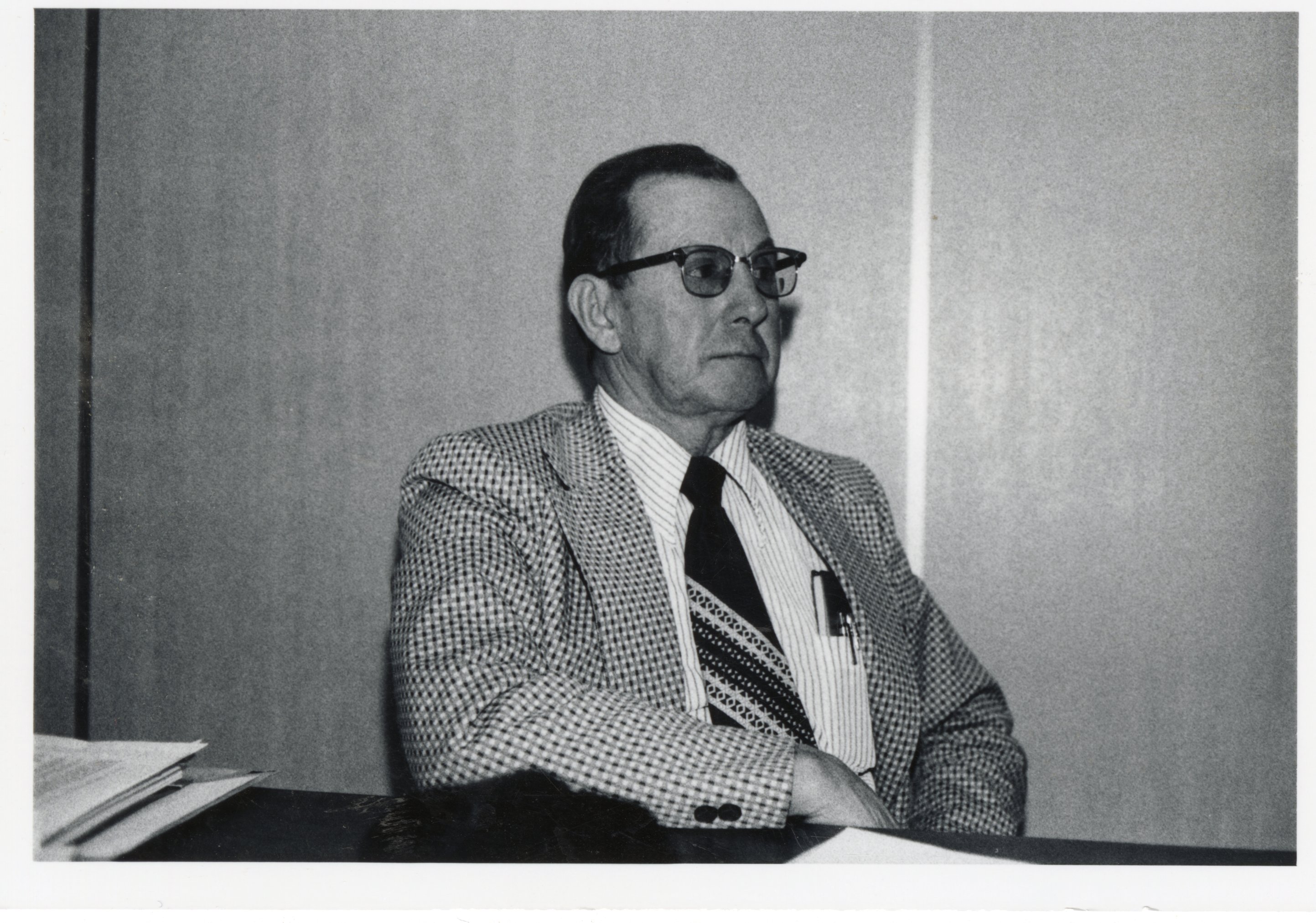 Unidentified man in suit sits at meeting