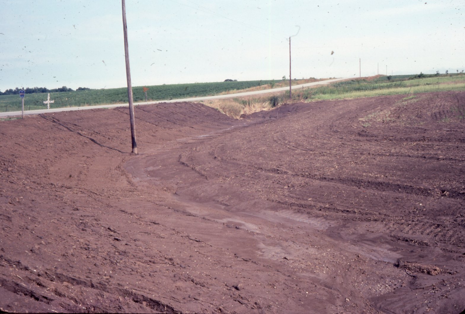 Muddy farmland by road