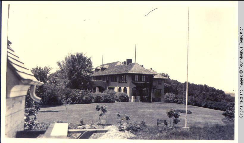 Grey house with lighting rods on roof