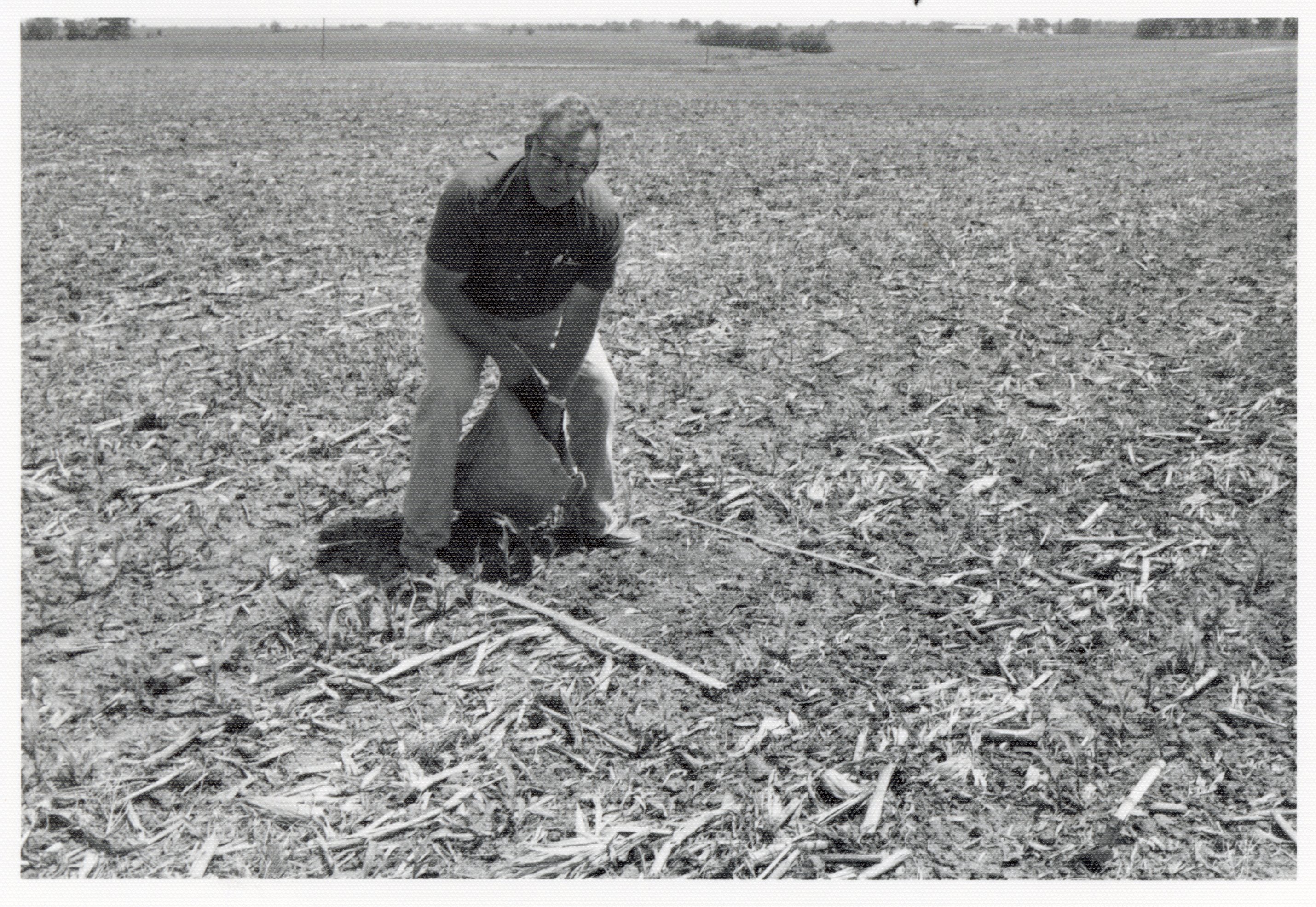 1978 Man holds bag of seed in no-till field