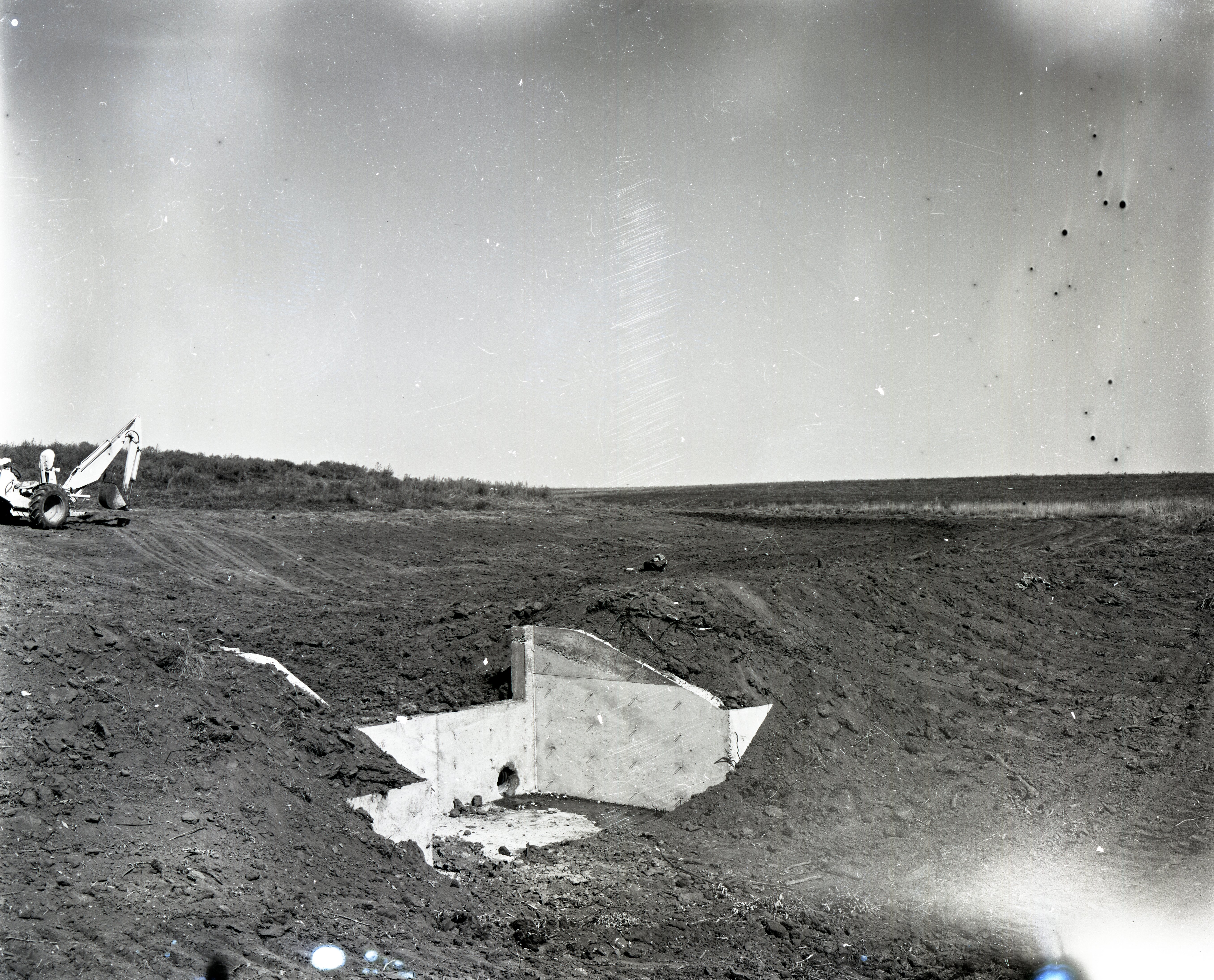 Water culvert surrounded by dirt that has been moved
