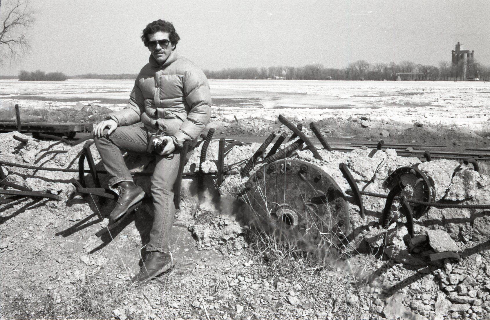 1978 Sid Mais  sits on old farm machinery