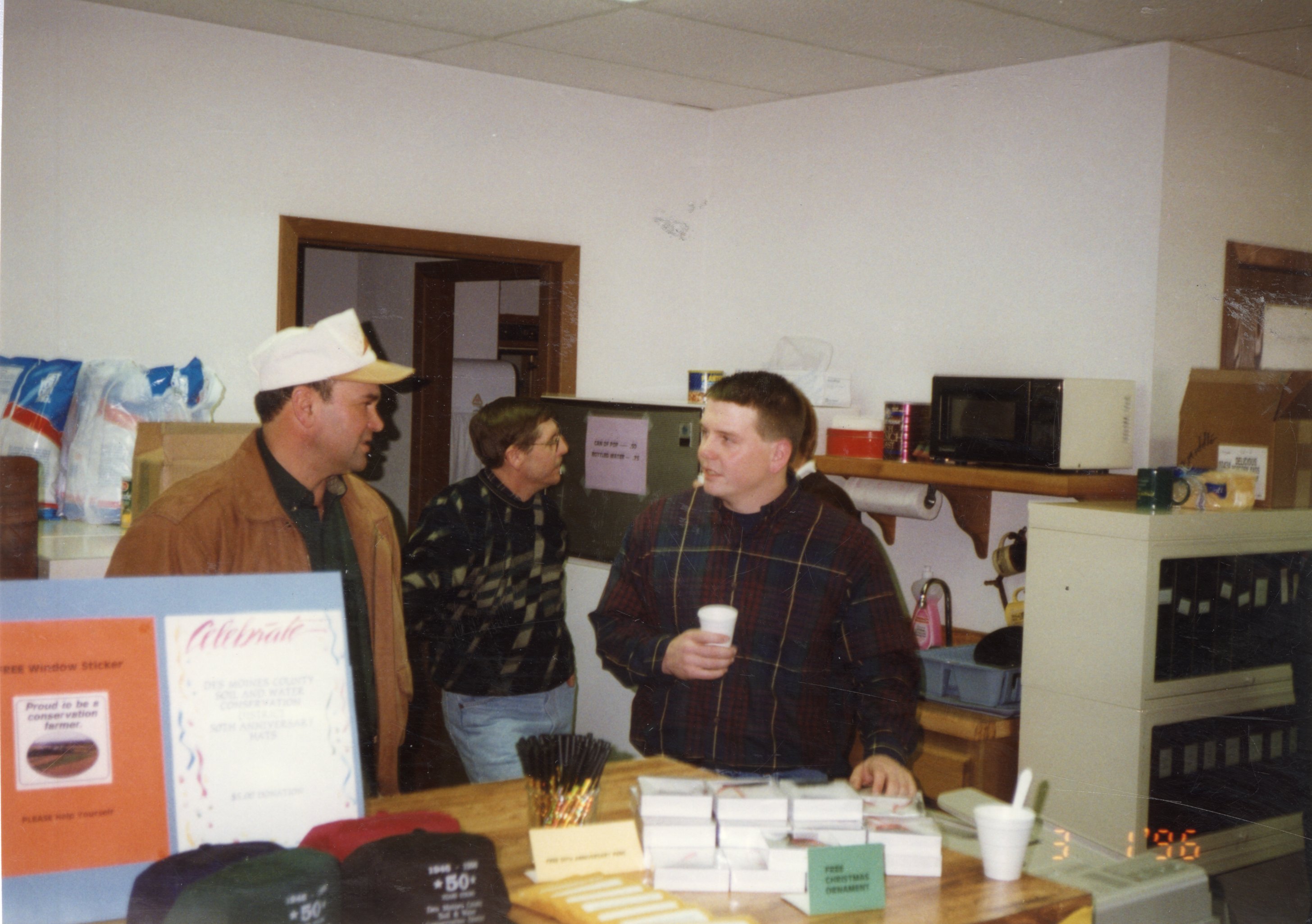 1996  Charles Neeley, Jim Jensen, and Drew DeLang stand at open house party