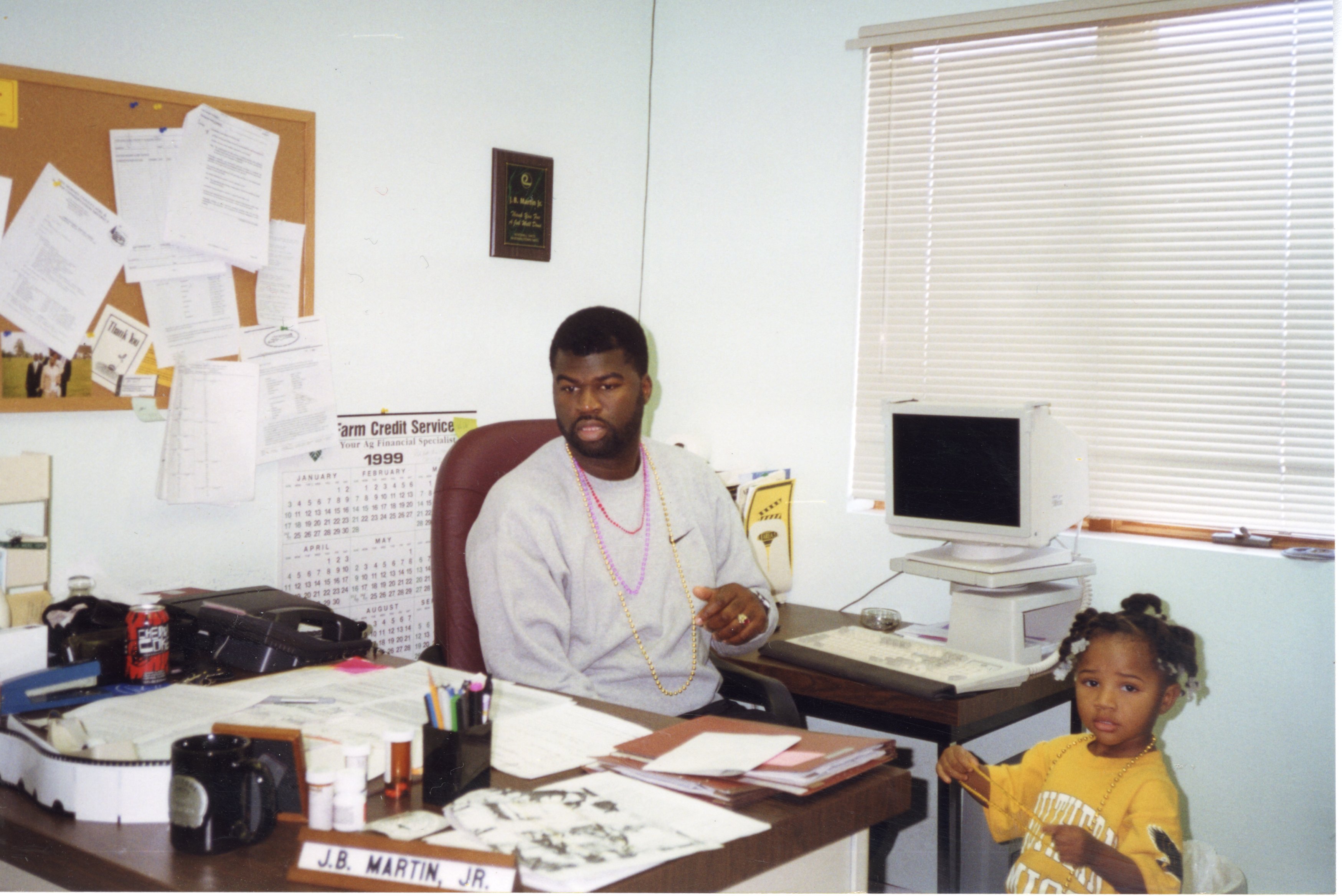 1999  District Conservationist J.B. Martin and his<br />
daughter, Jaria,  sit in his office