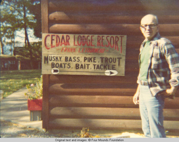 John Hedbereg standing by Cedar Lodge sign