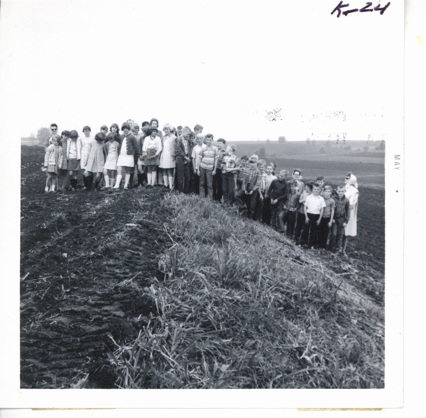 Preston fifth graders observing Harold Sullivan farm's back slope terrace, 1969