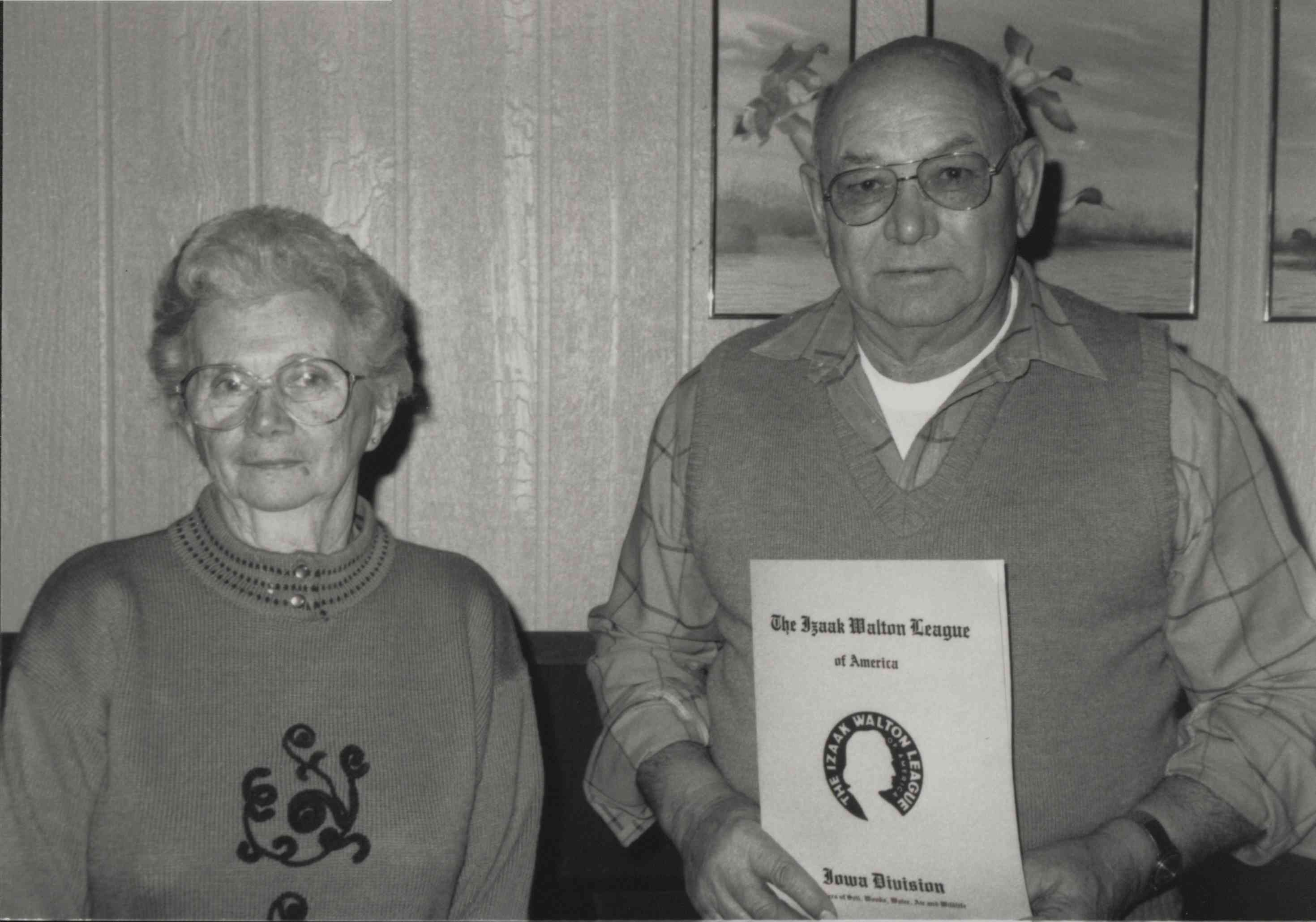 Photo of Woman standing next to man holding Isaac Walton League Document