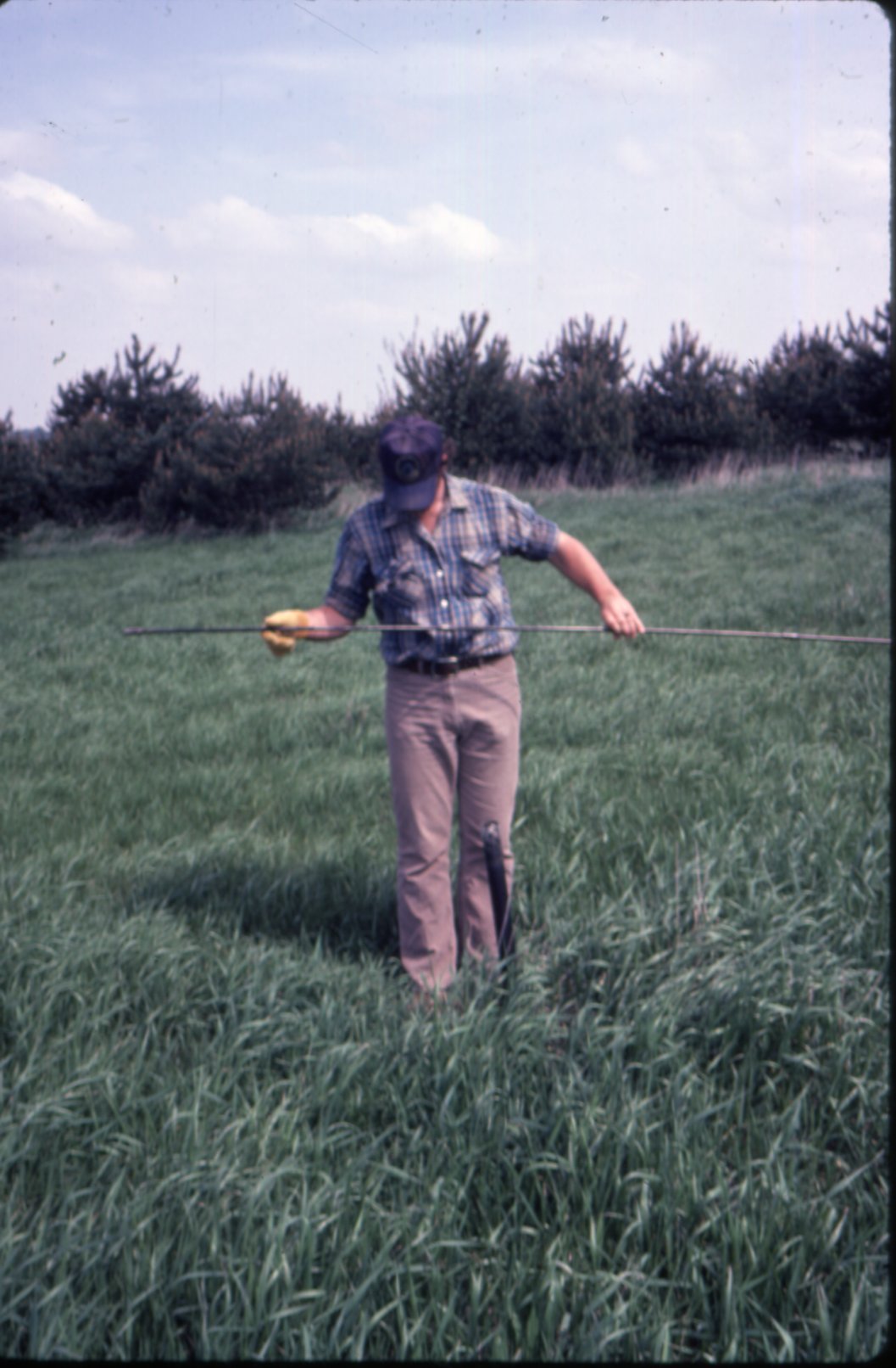 Tim [?] checking water level depth, 1983