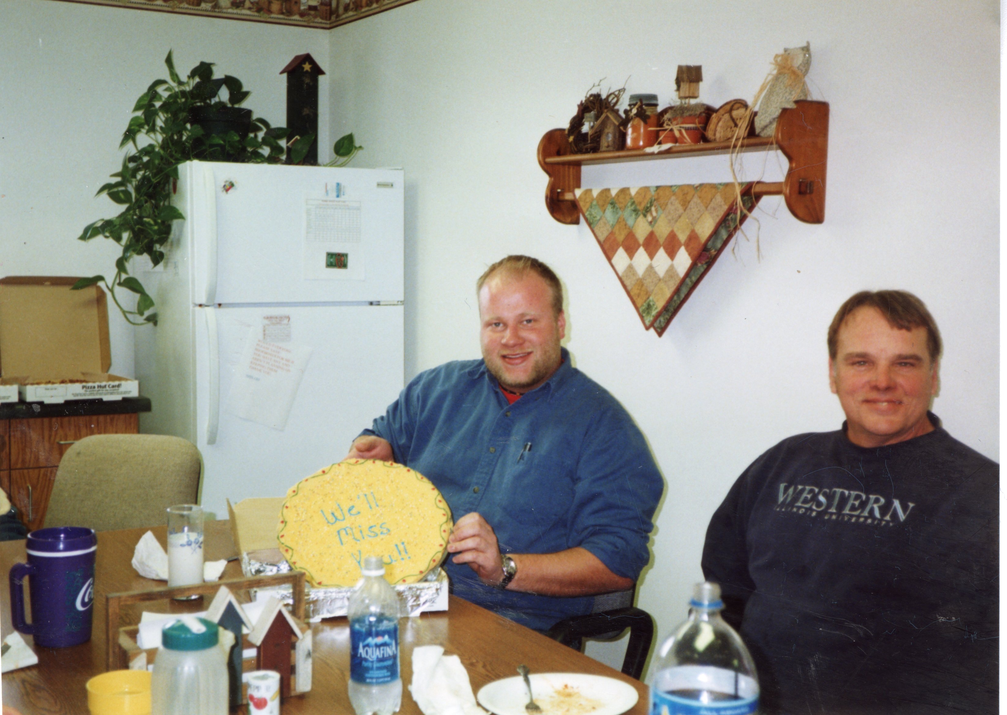 2005  NRCS Soil Conservationist TJ Mathis and District Employee Dale Schmeiser  sit at a table after a lunch honoring T.J. Mathis who is leaving