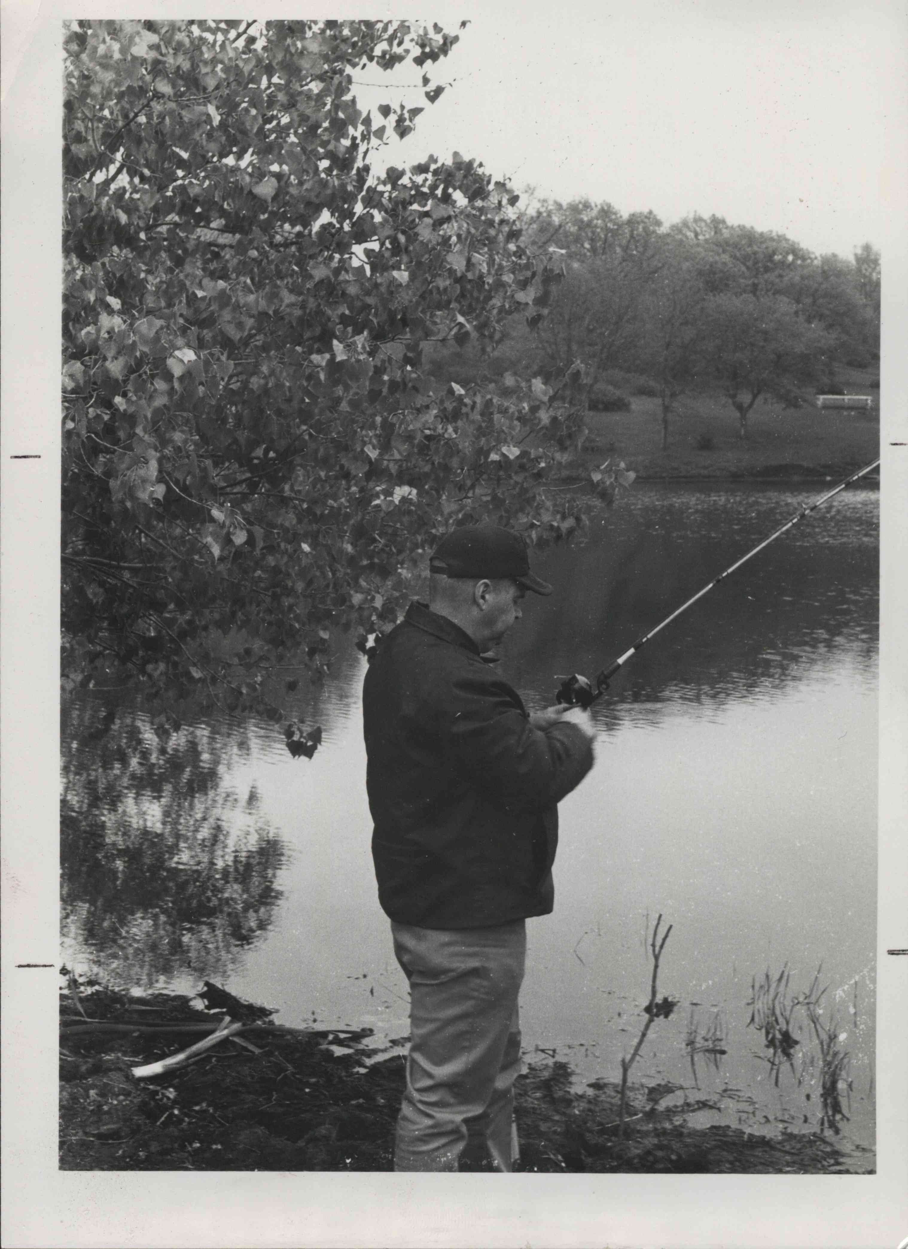 Man Fishing by Tree