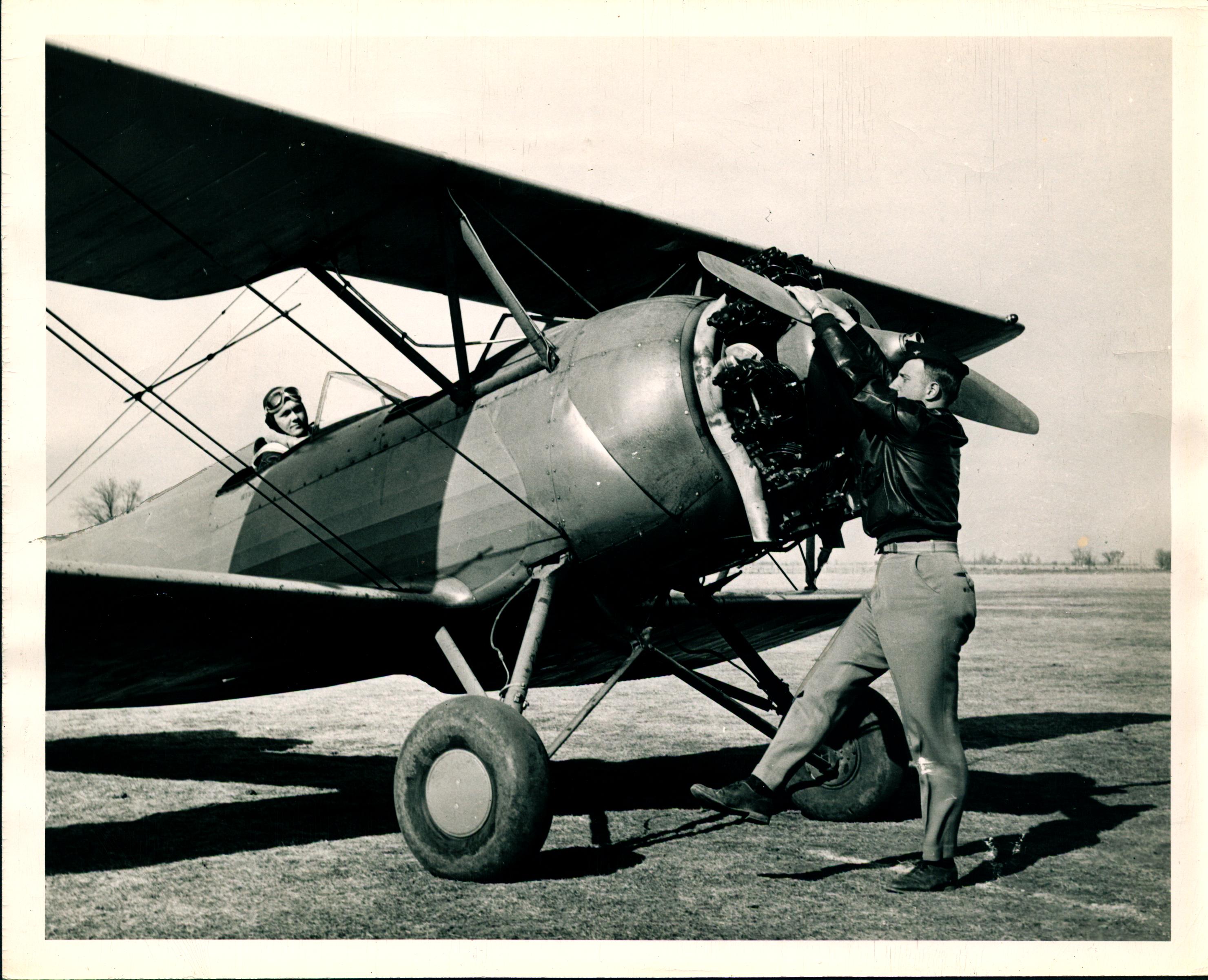 0028_Norman Van Grop, Flight Instructor Spinning the Propellor