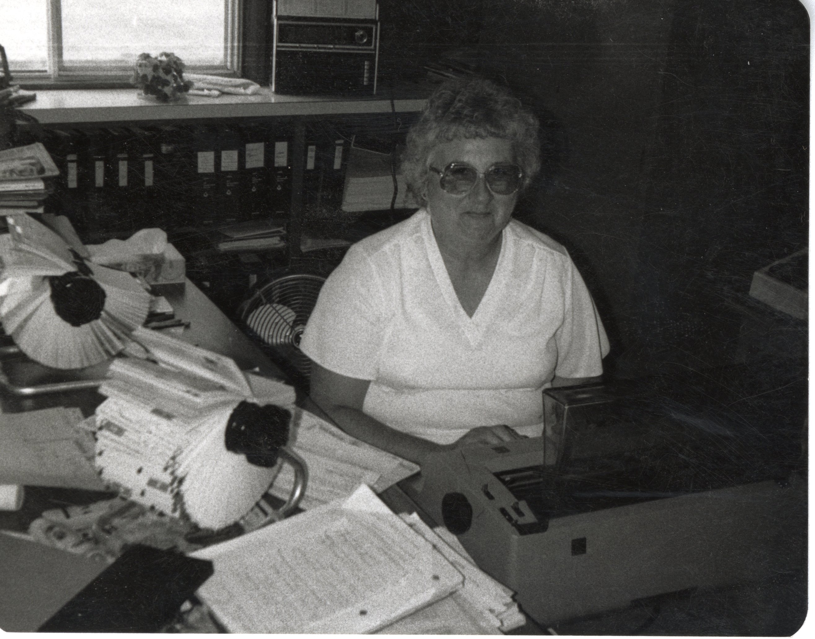 Chris Botts is typing at her desk