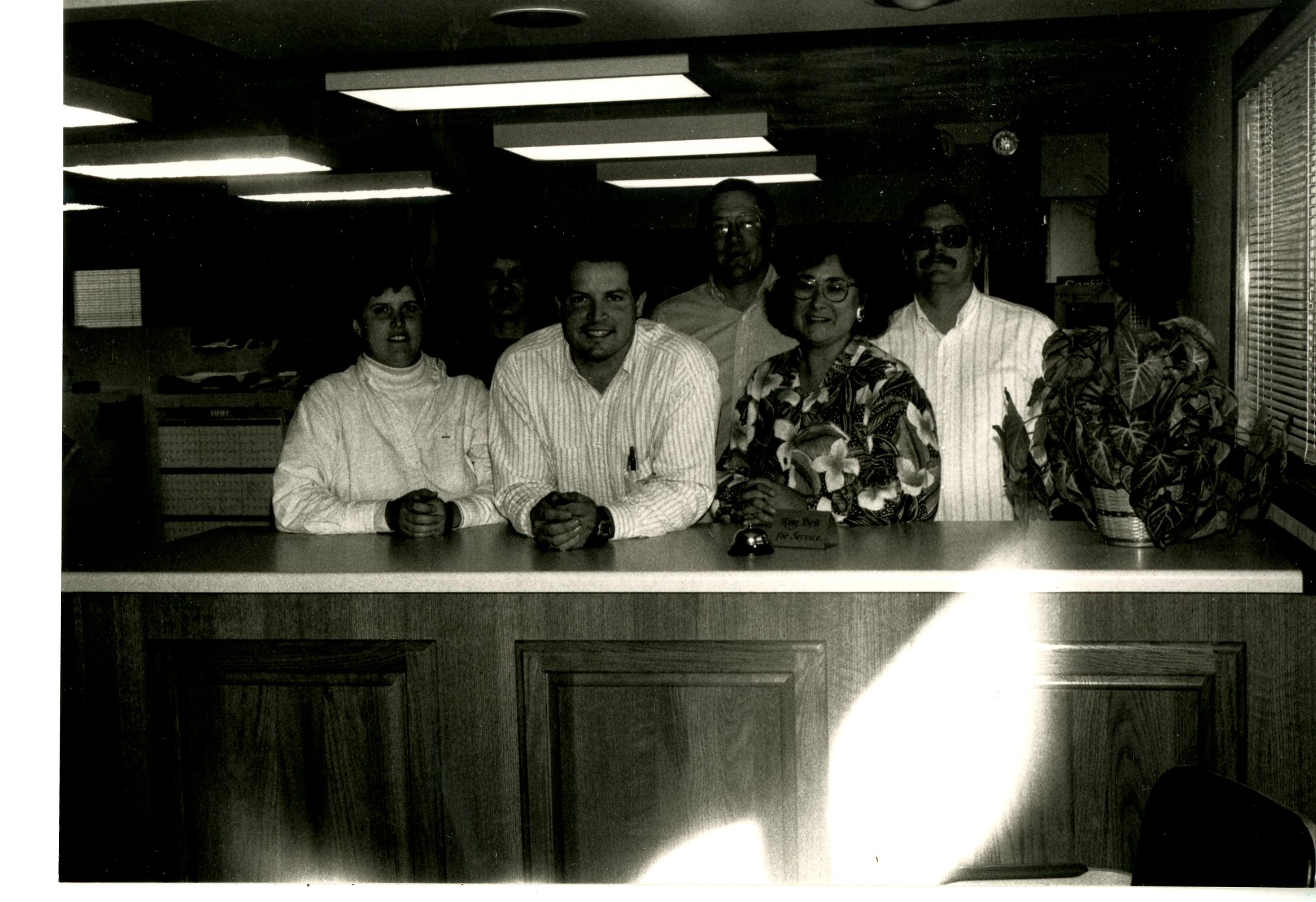Five People Standing At Service Center Counter