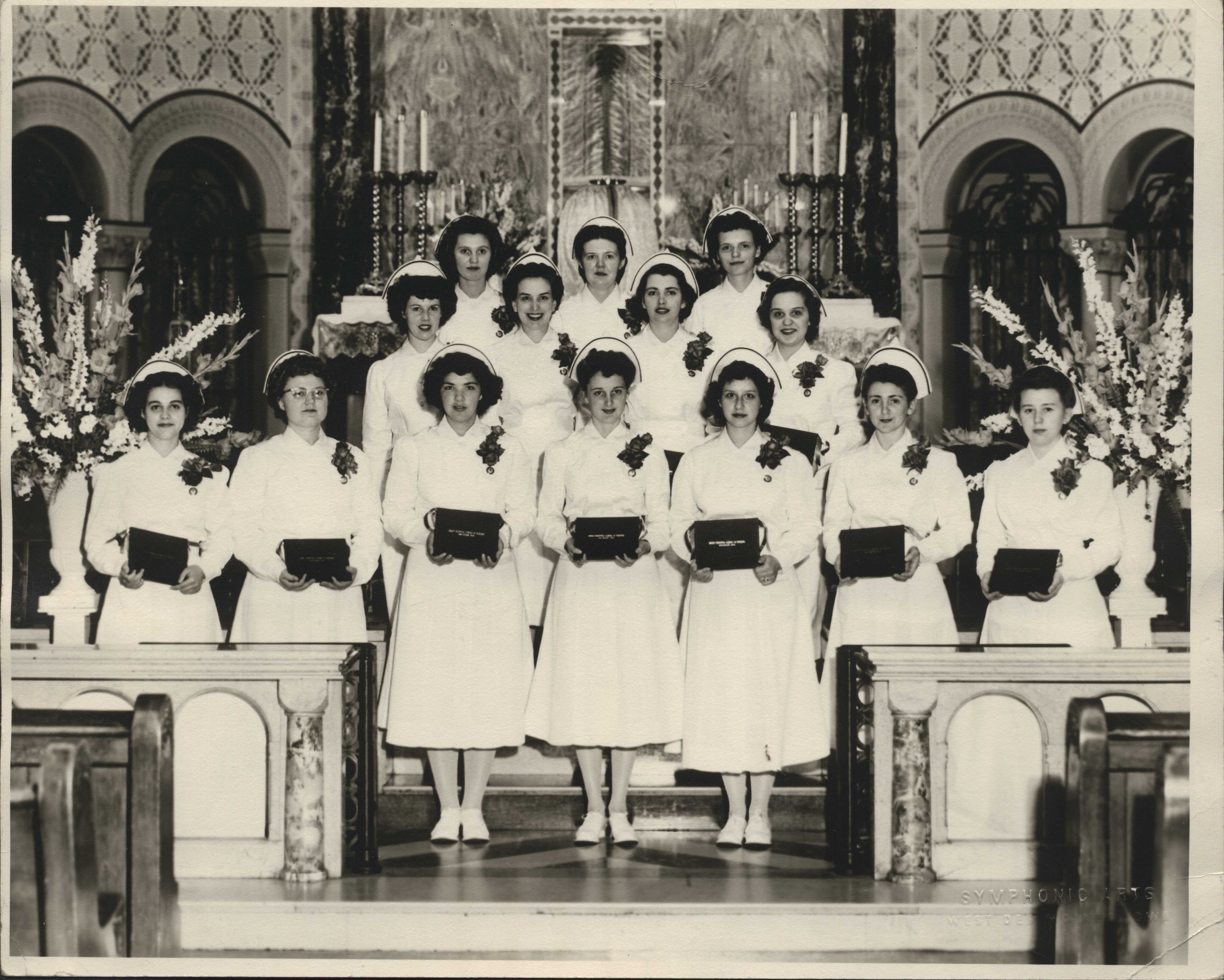 Class of 1949 with diplomas in the Cathedral.