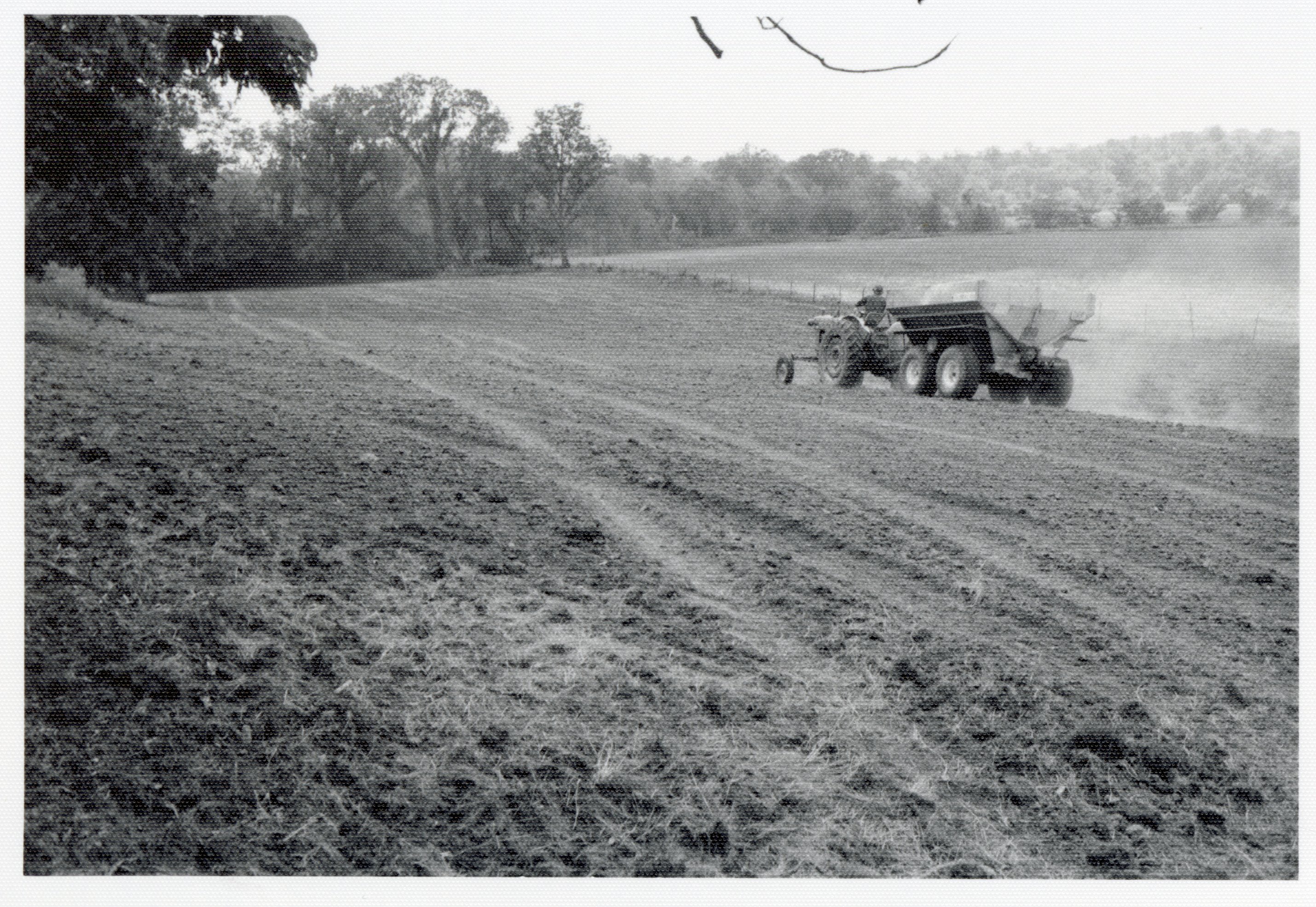 1978 Man on tractor with wagon plants seed
