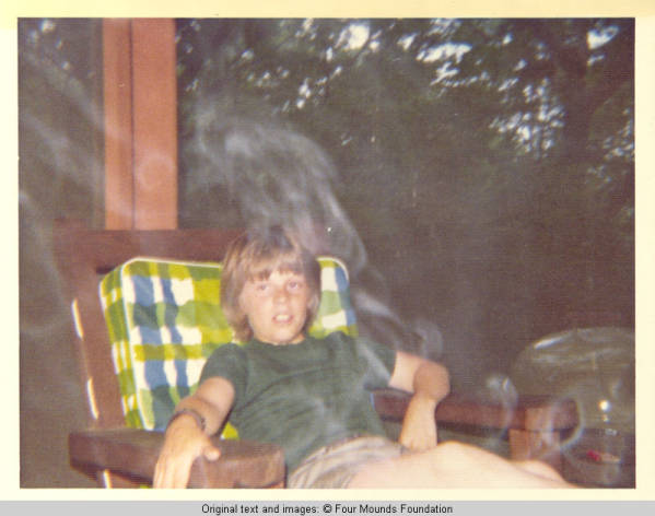 John, Jr. sitting in the smoke on the screened in porch