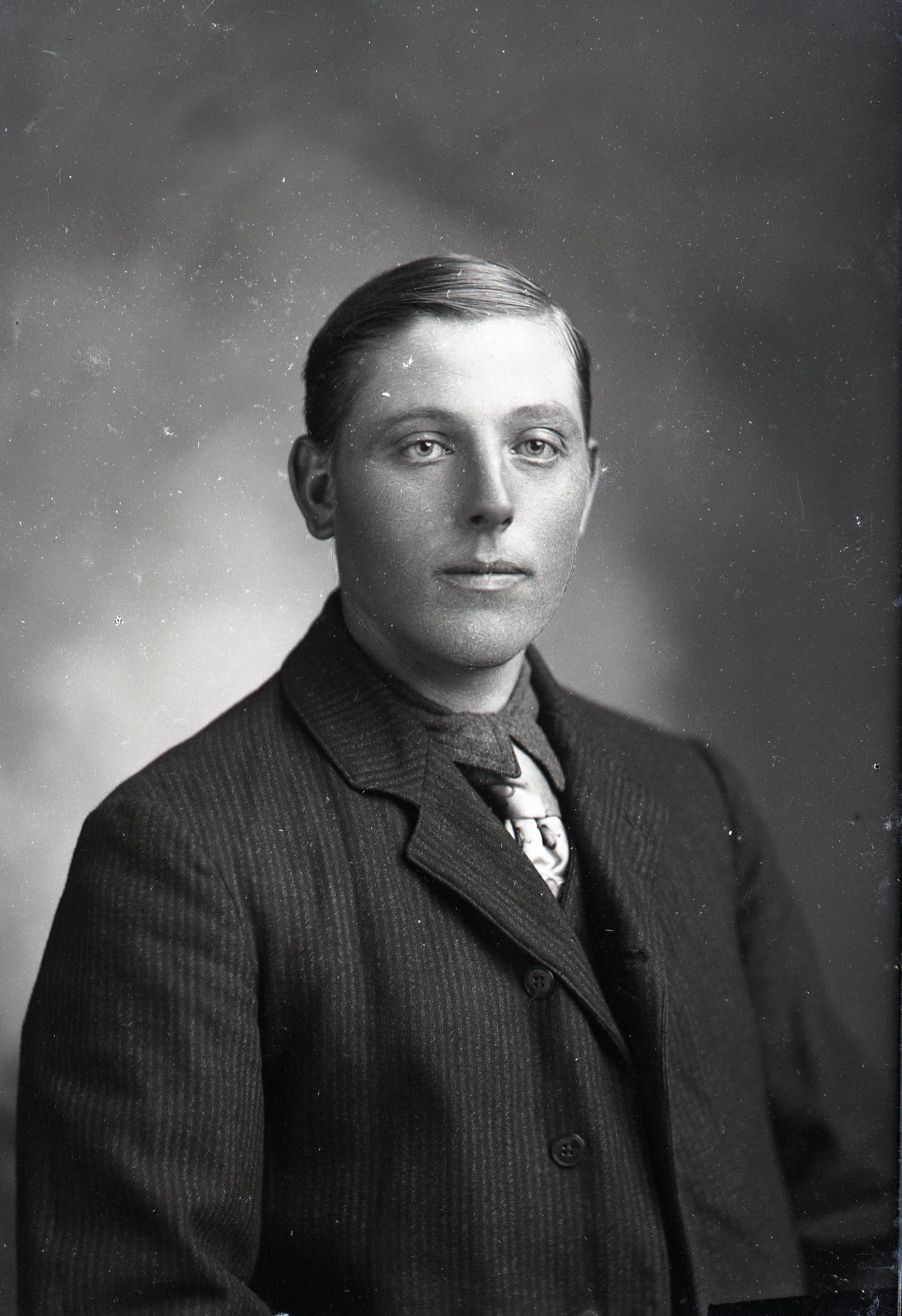 Man in coat, seated