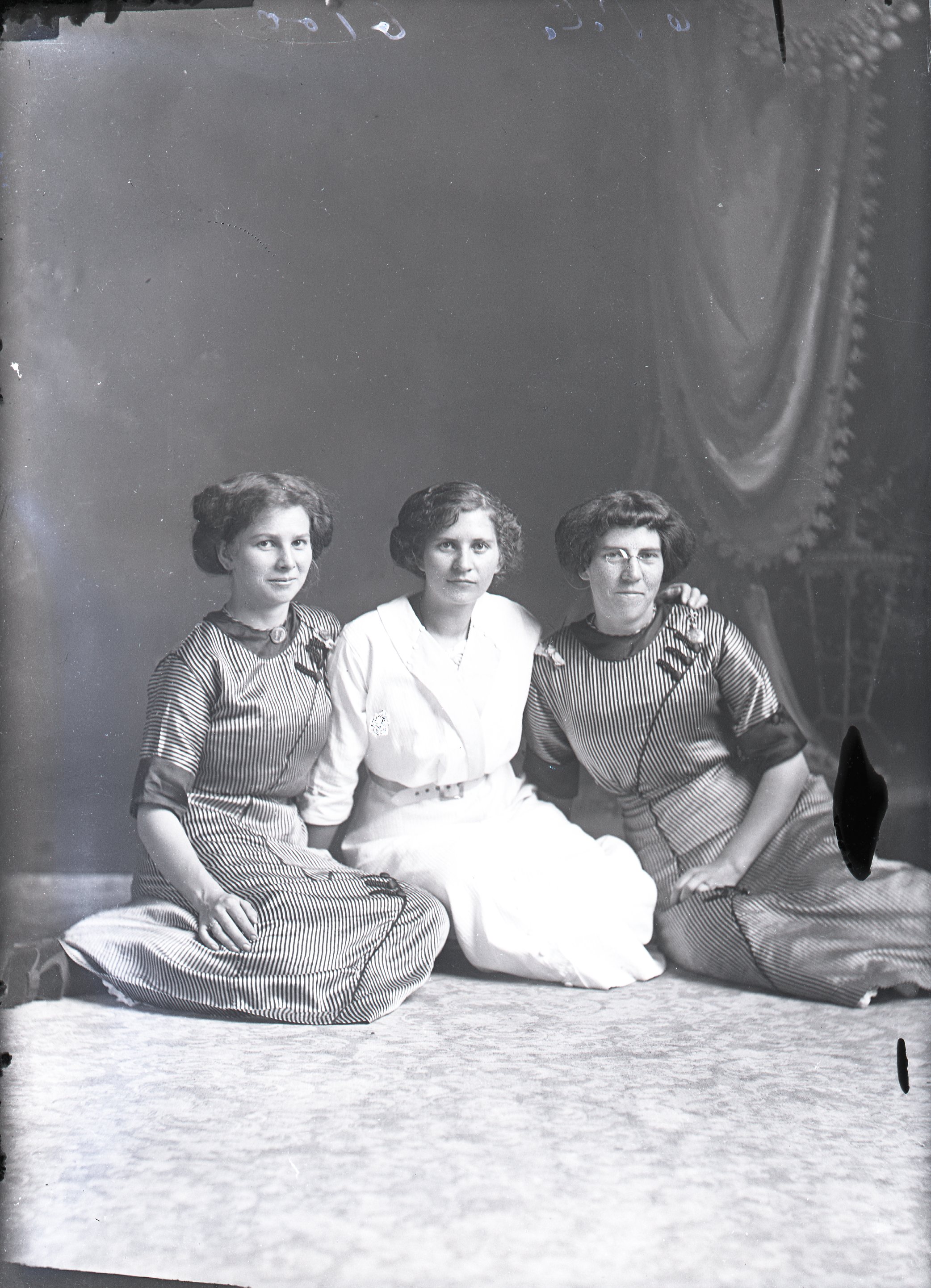 Three women seated on floor