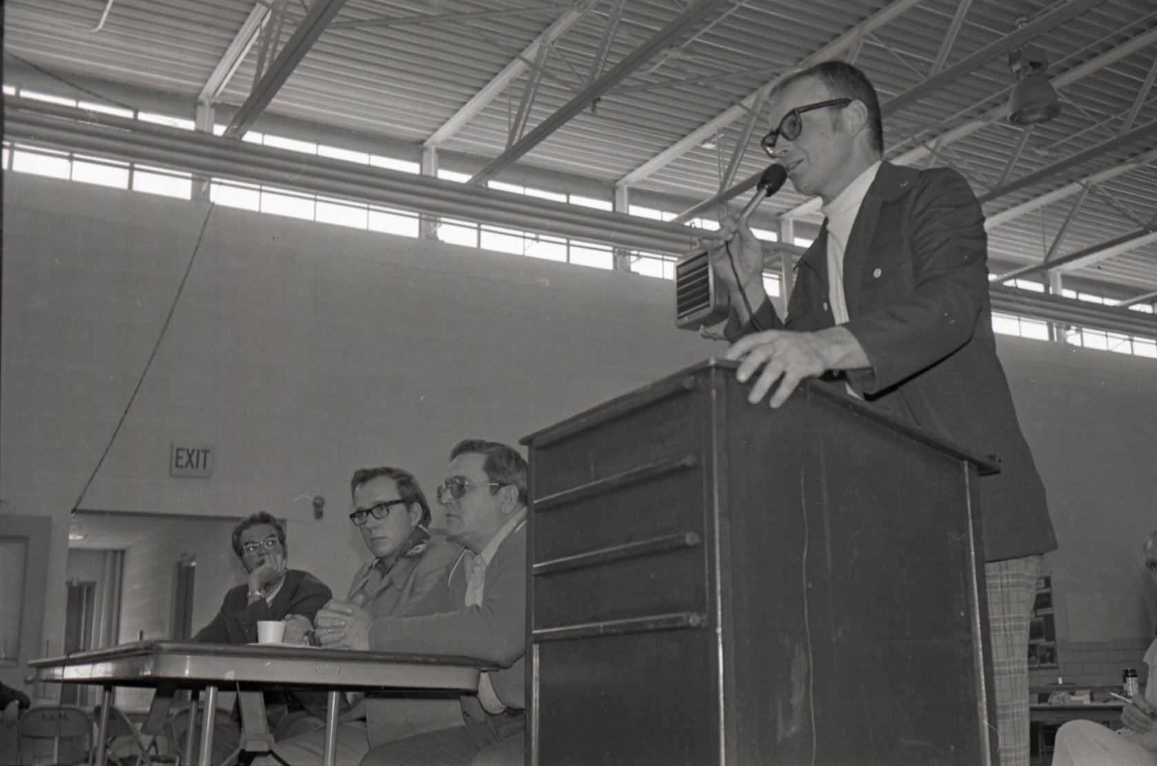 1976  Men at microphone 