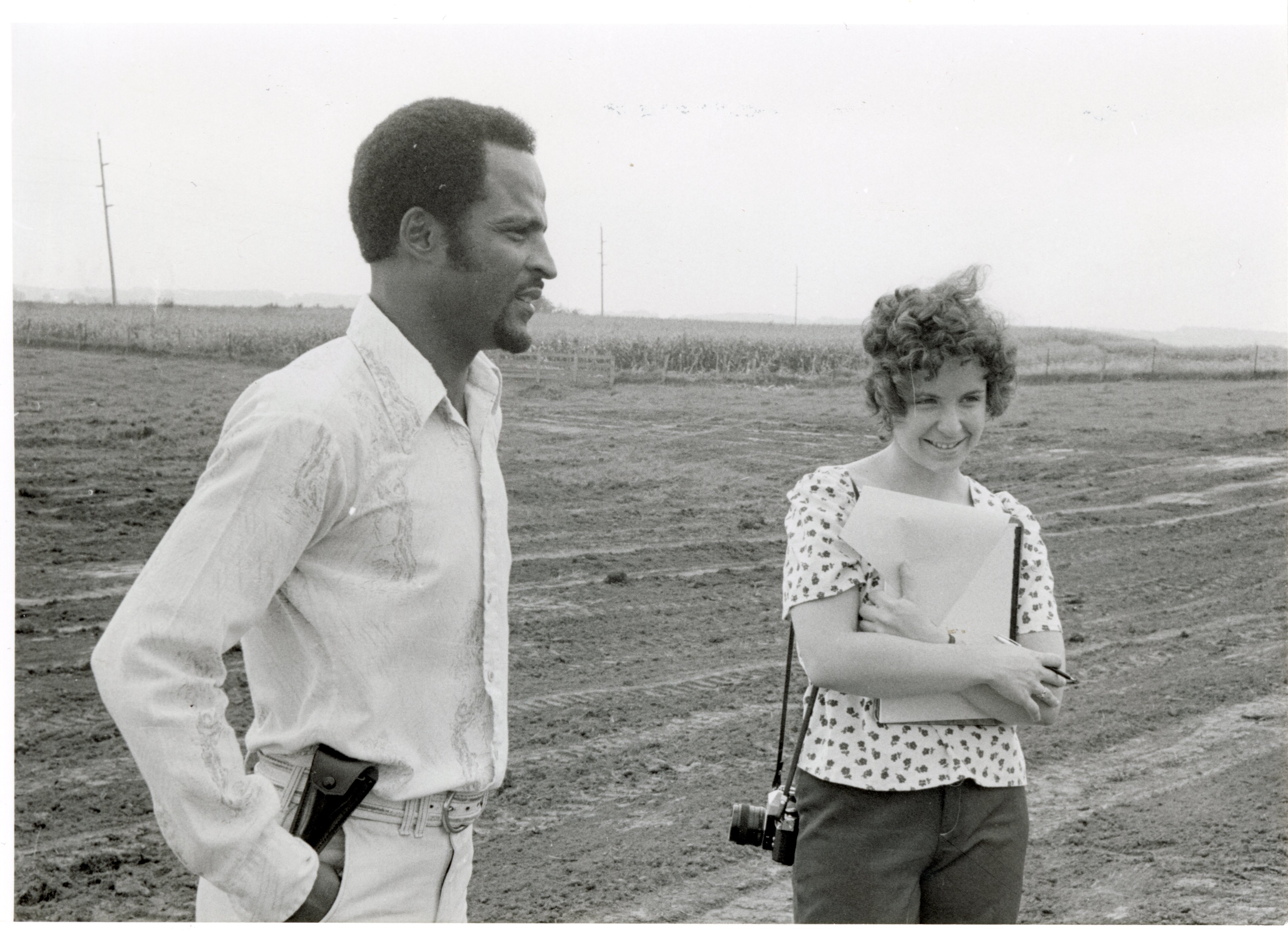 1979  William Baugh talks to woman in a field