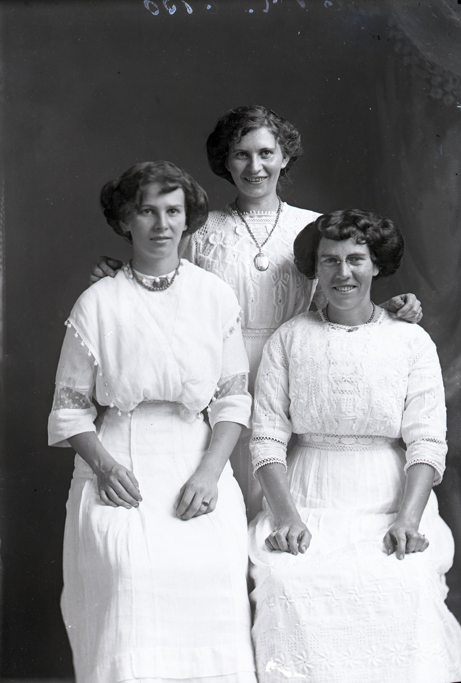Three women in white dresses