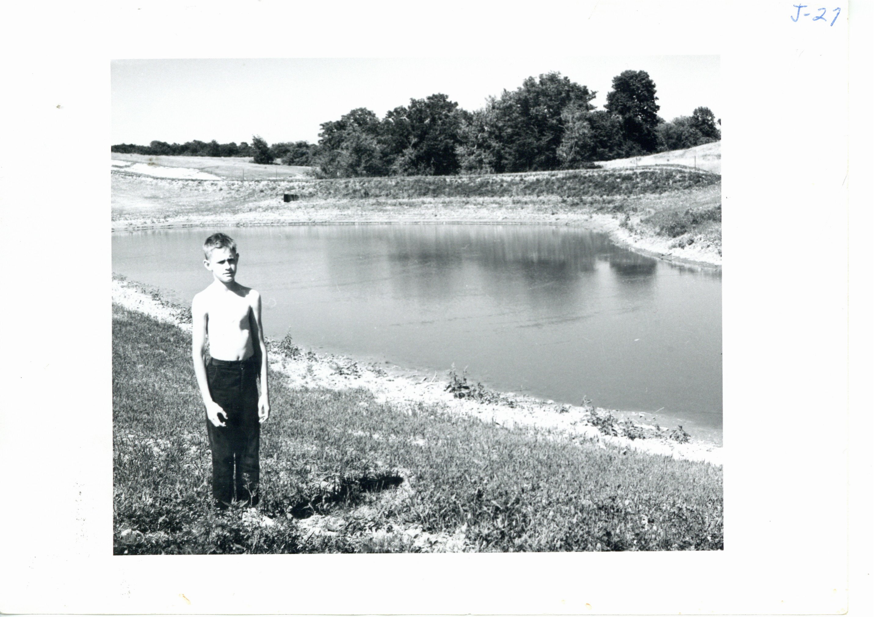 Pipe spillway erosion control dam and child, 1965