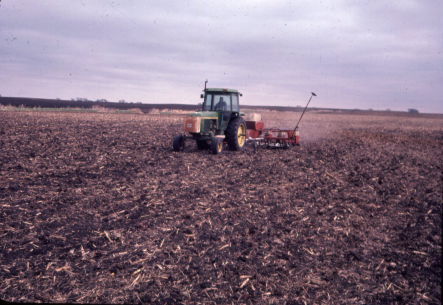 Tractor plowing field, 1981