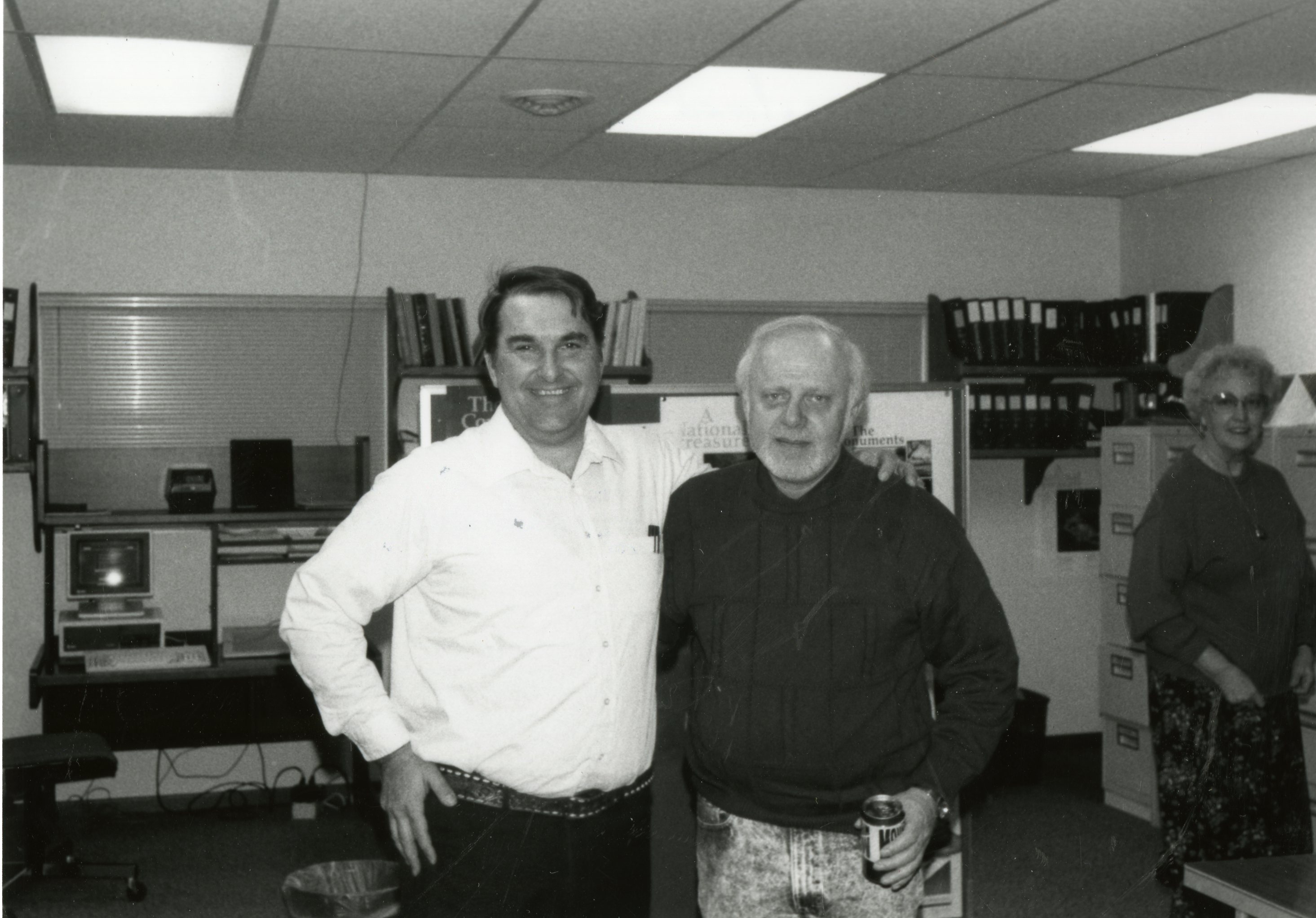 1992 - Two smiling men stand in office
