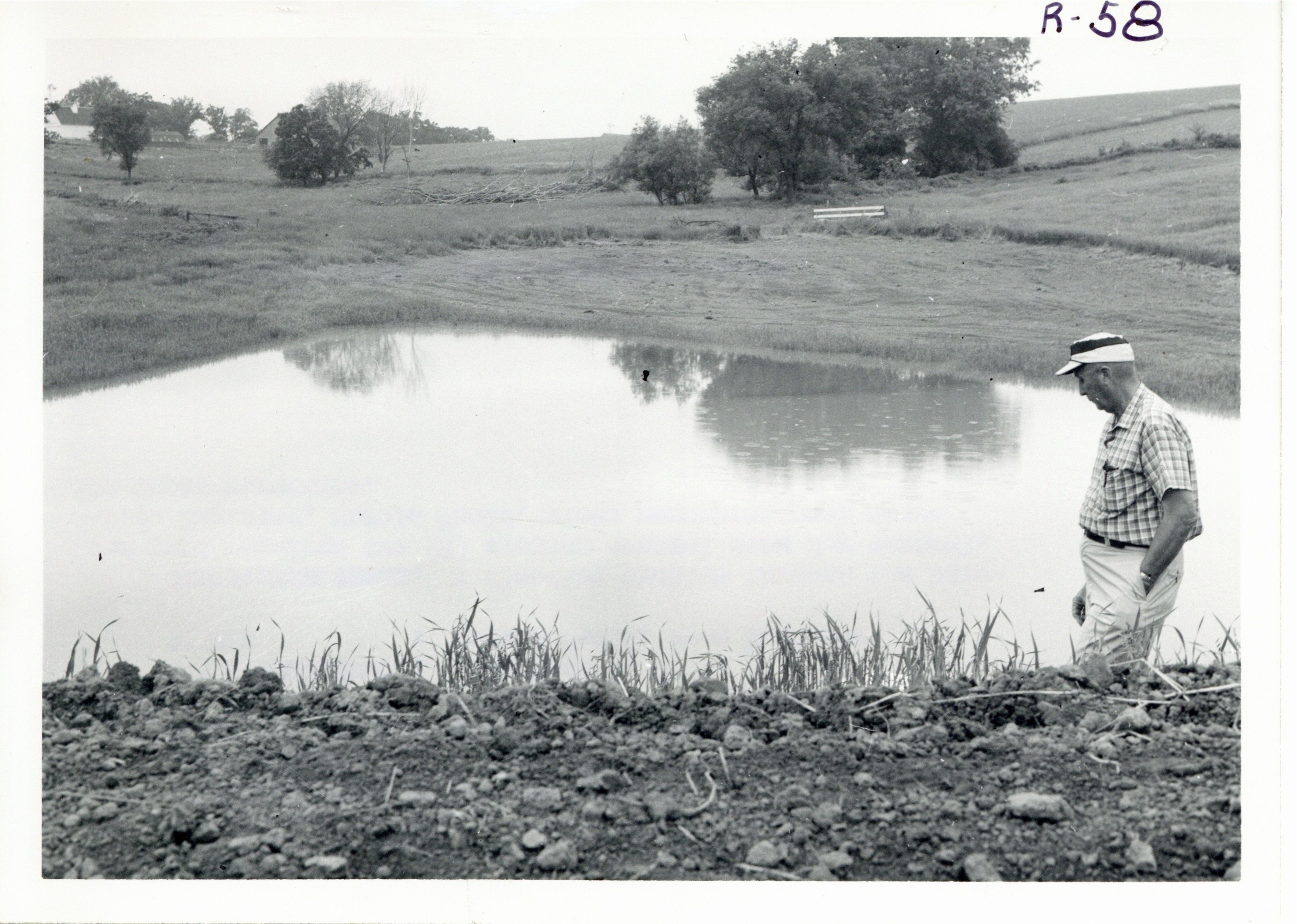 Engineer Harold Shold inspecting erosion control dam, 1967