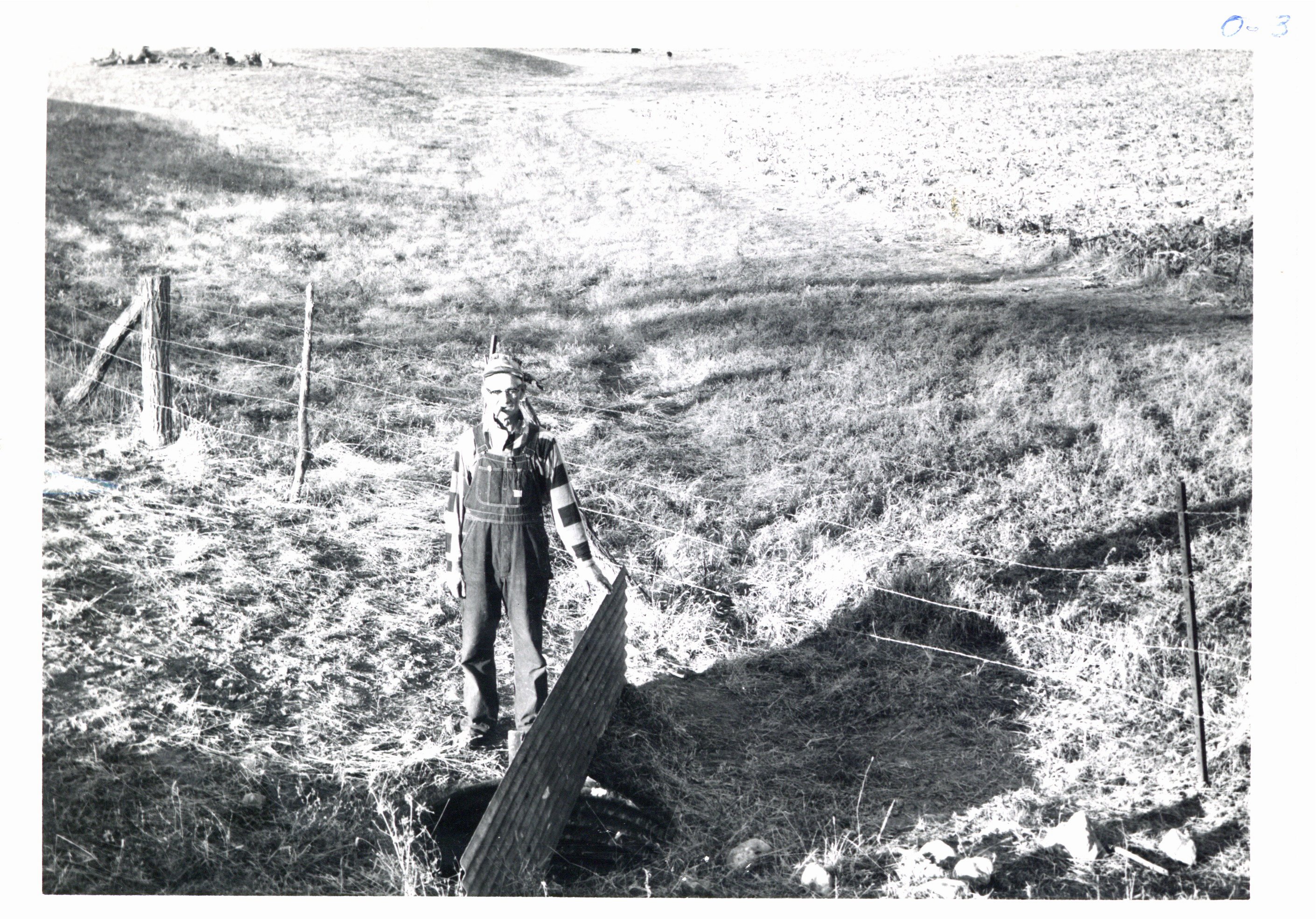 John Wall next to outlet of earth dam, 1964