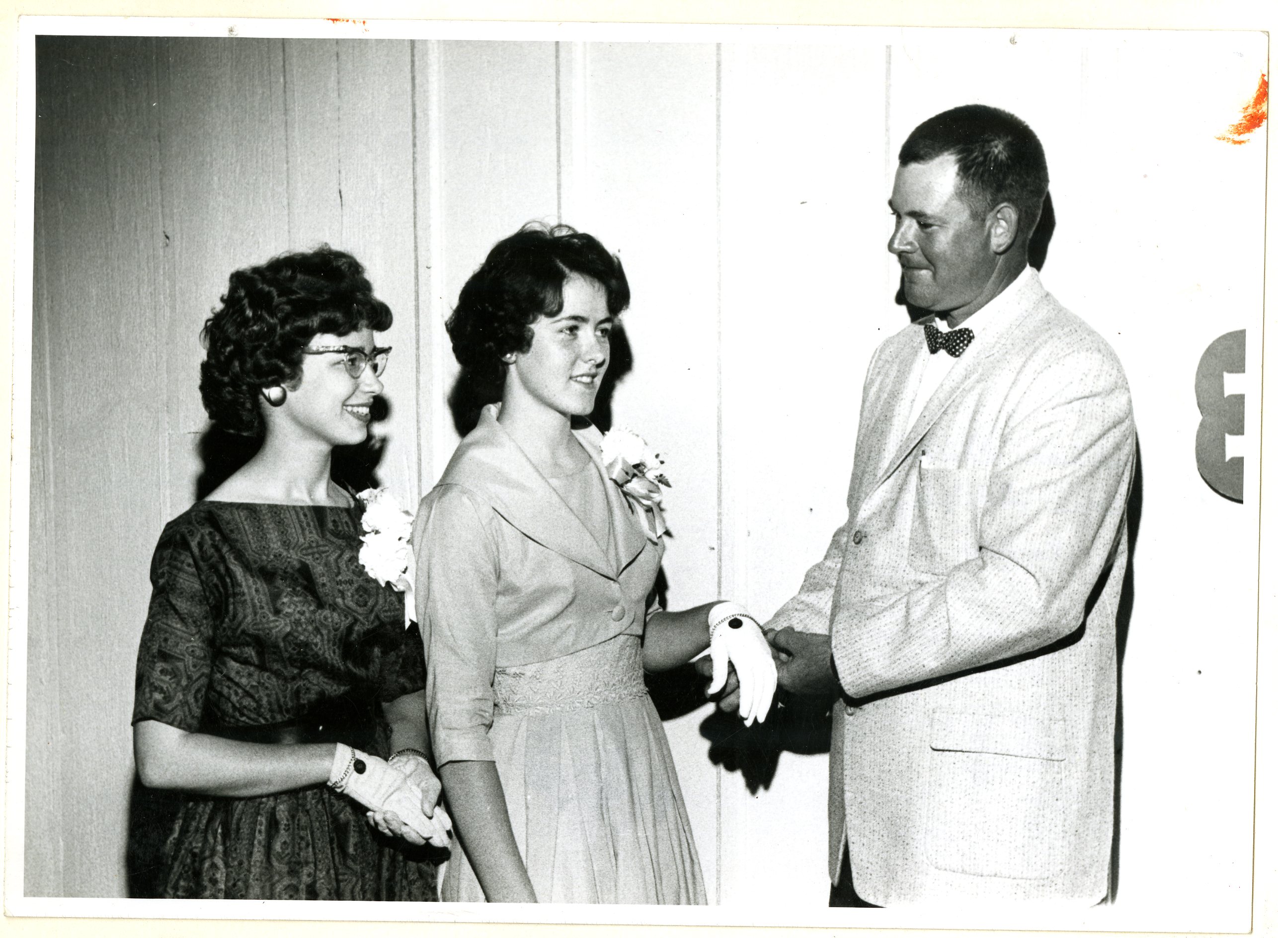 Three unidentified young adults at ceremony