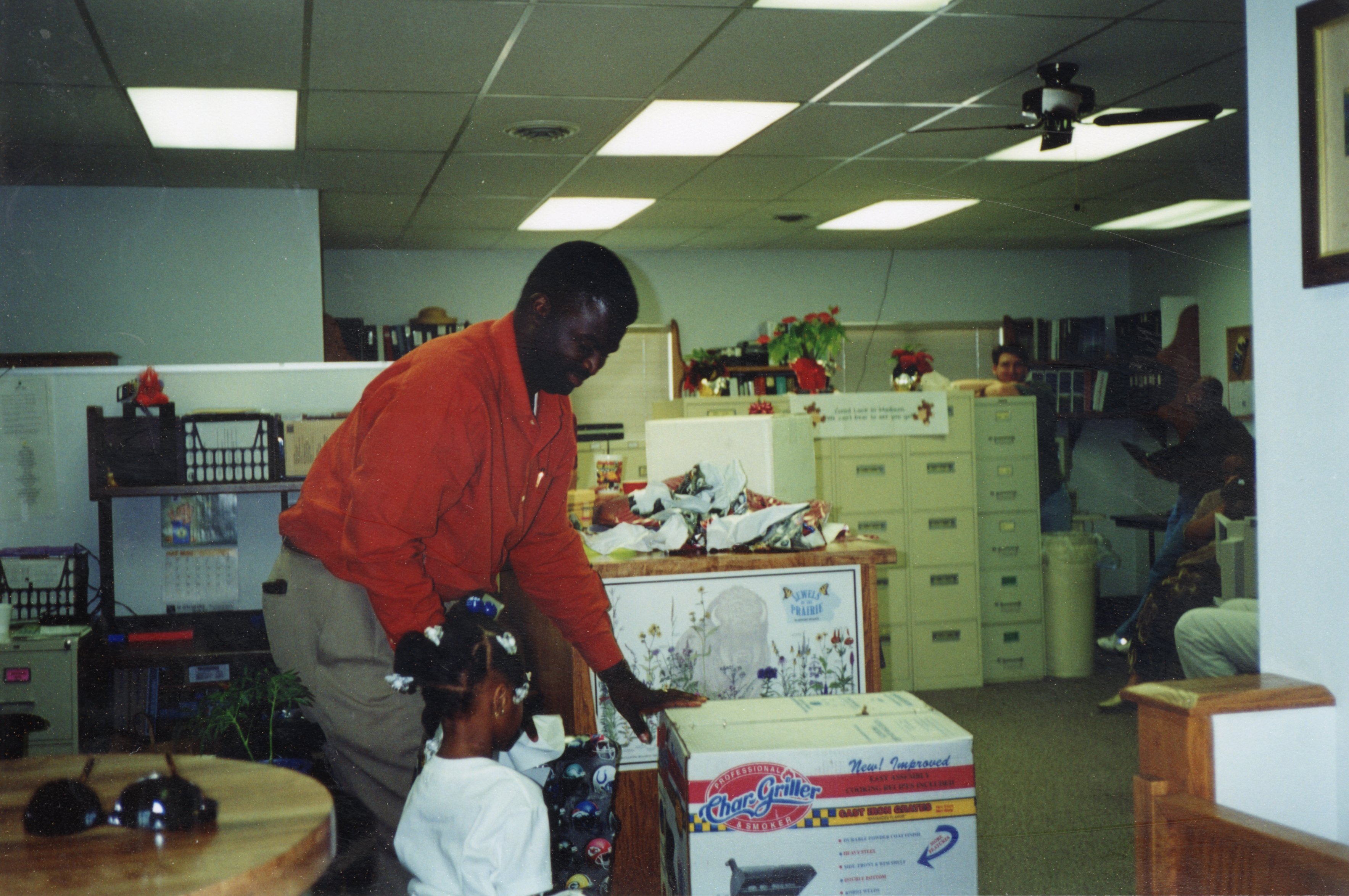 2000  J.B.Martin and daughter Jaria open a present at his going away party