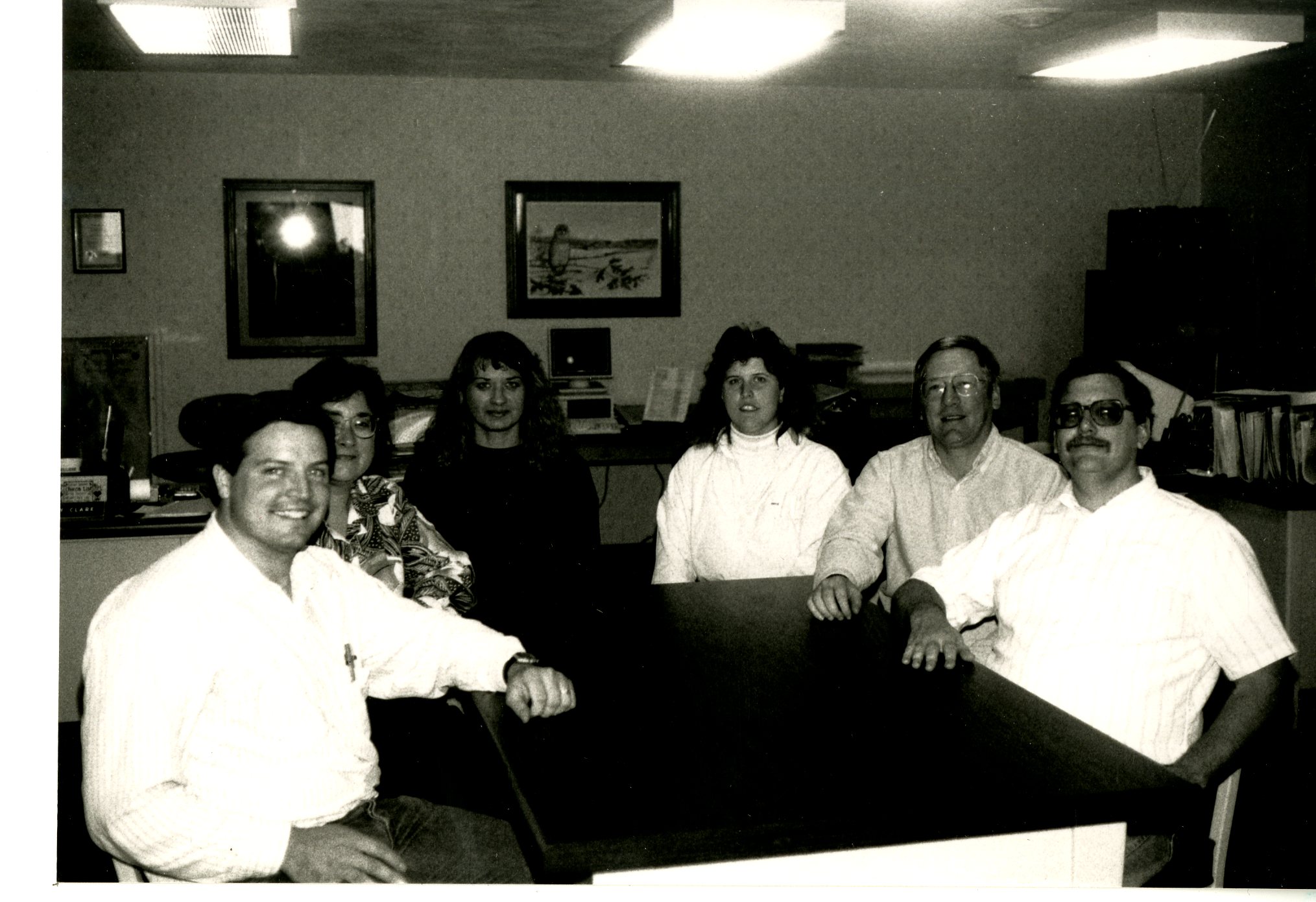 Six People Sitting Around Office Table