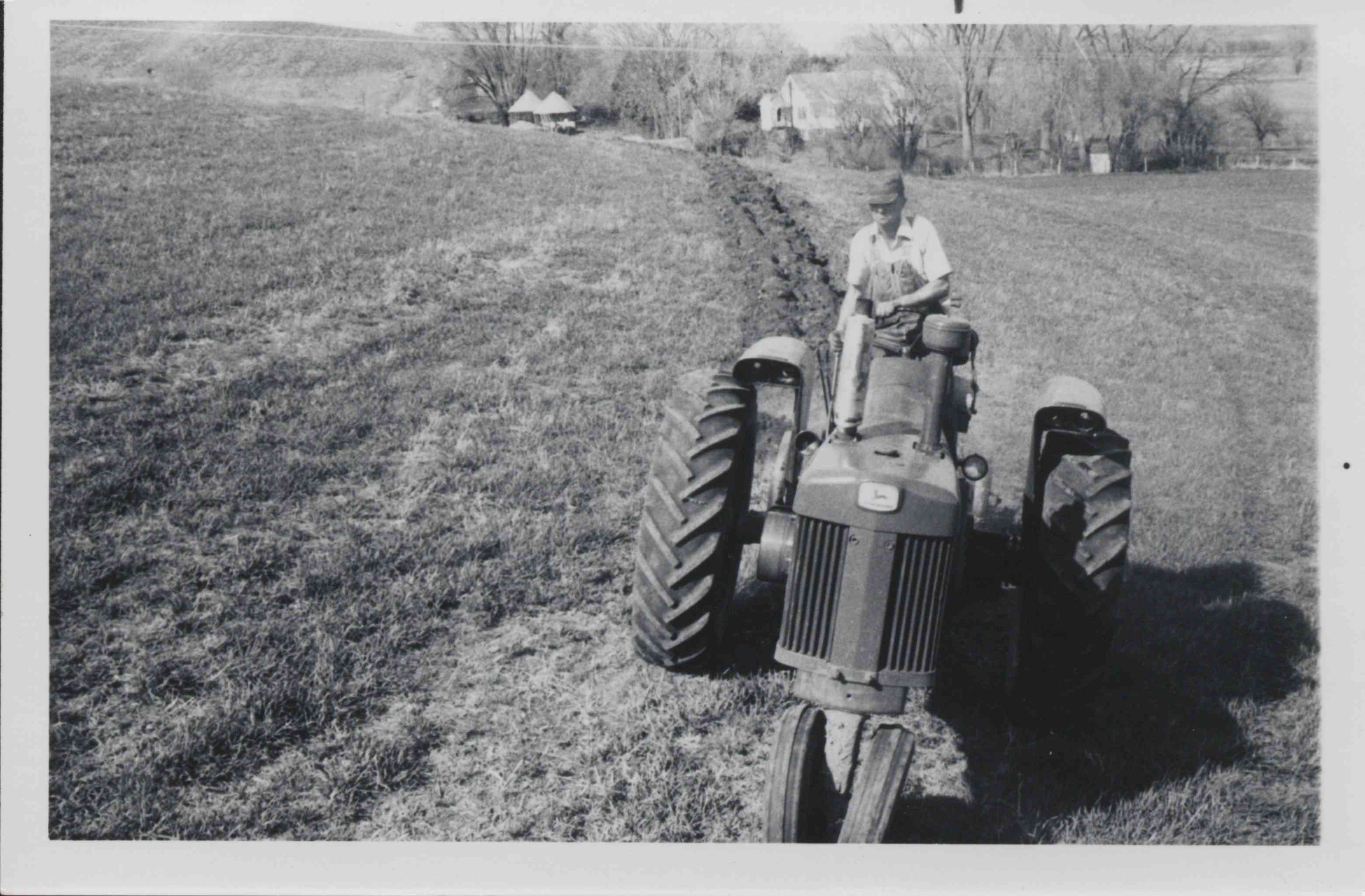 Man on Tractor Plowing Field