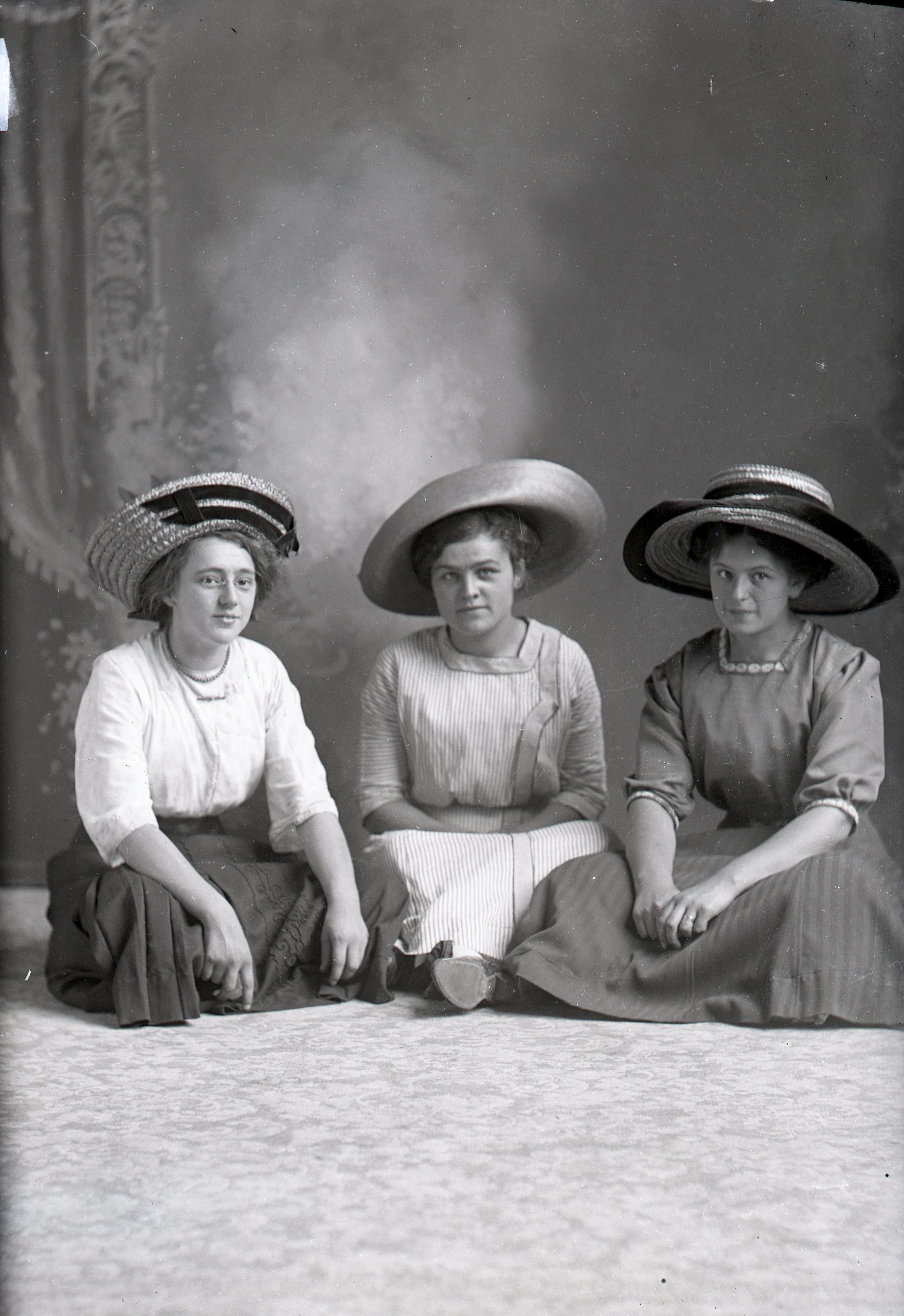 Three women sitting on floor
