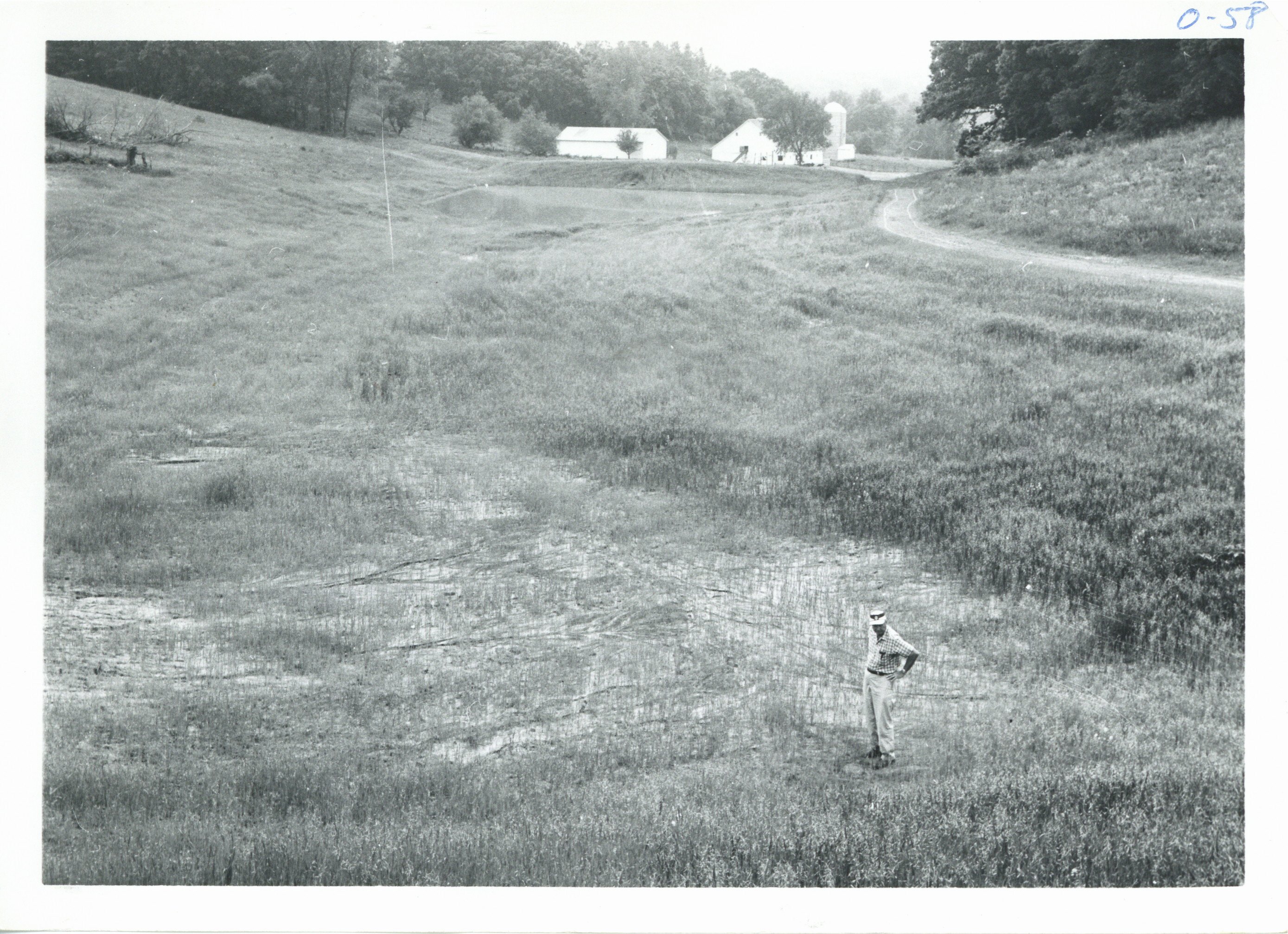 Harold Shold inspecting Marshall farm, 1967