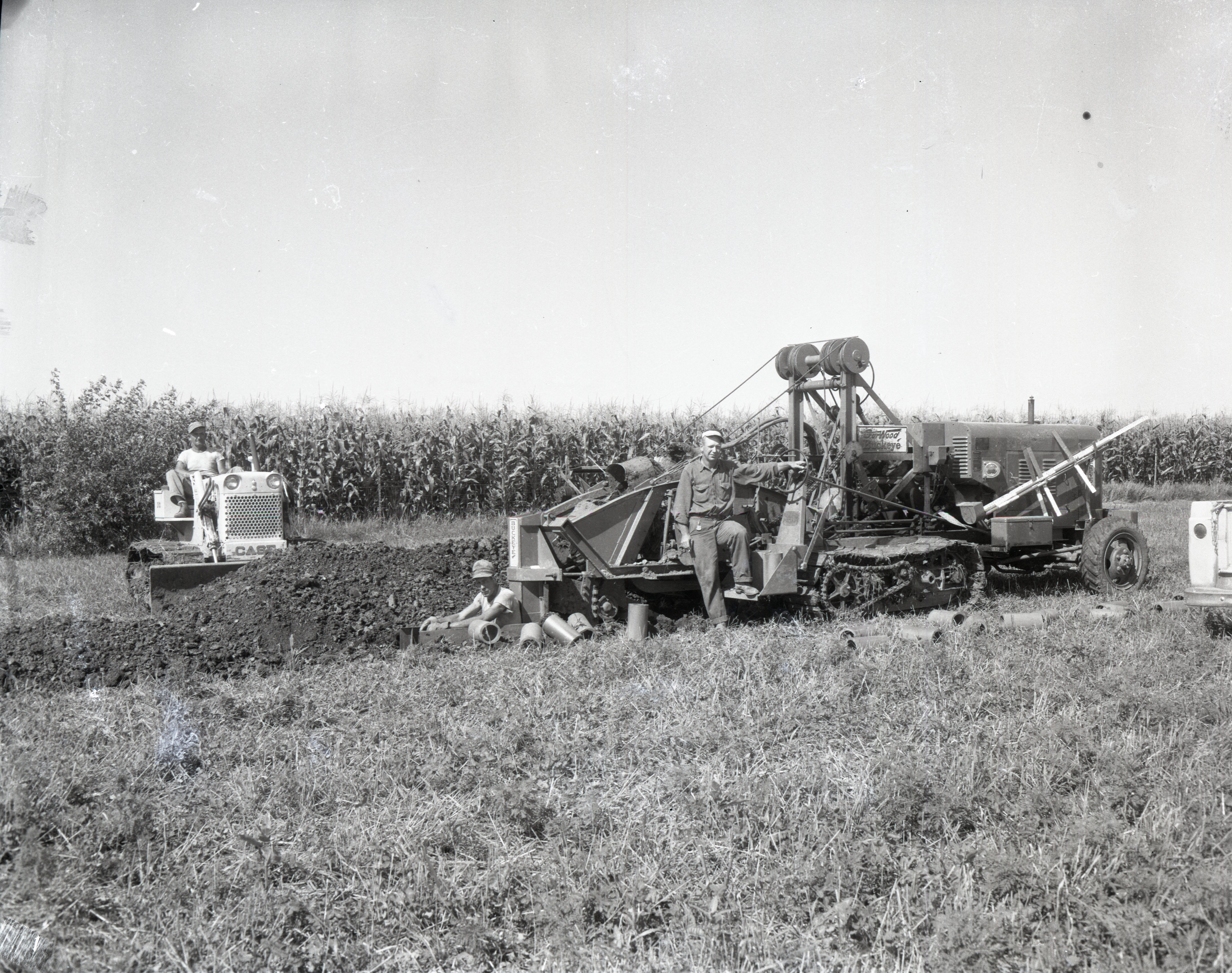 Ken Springsteen and two other men operate farm machinery in a field