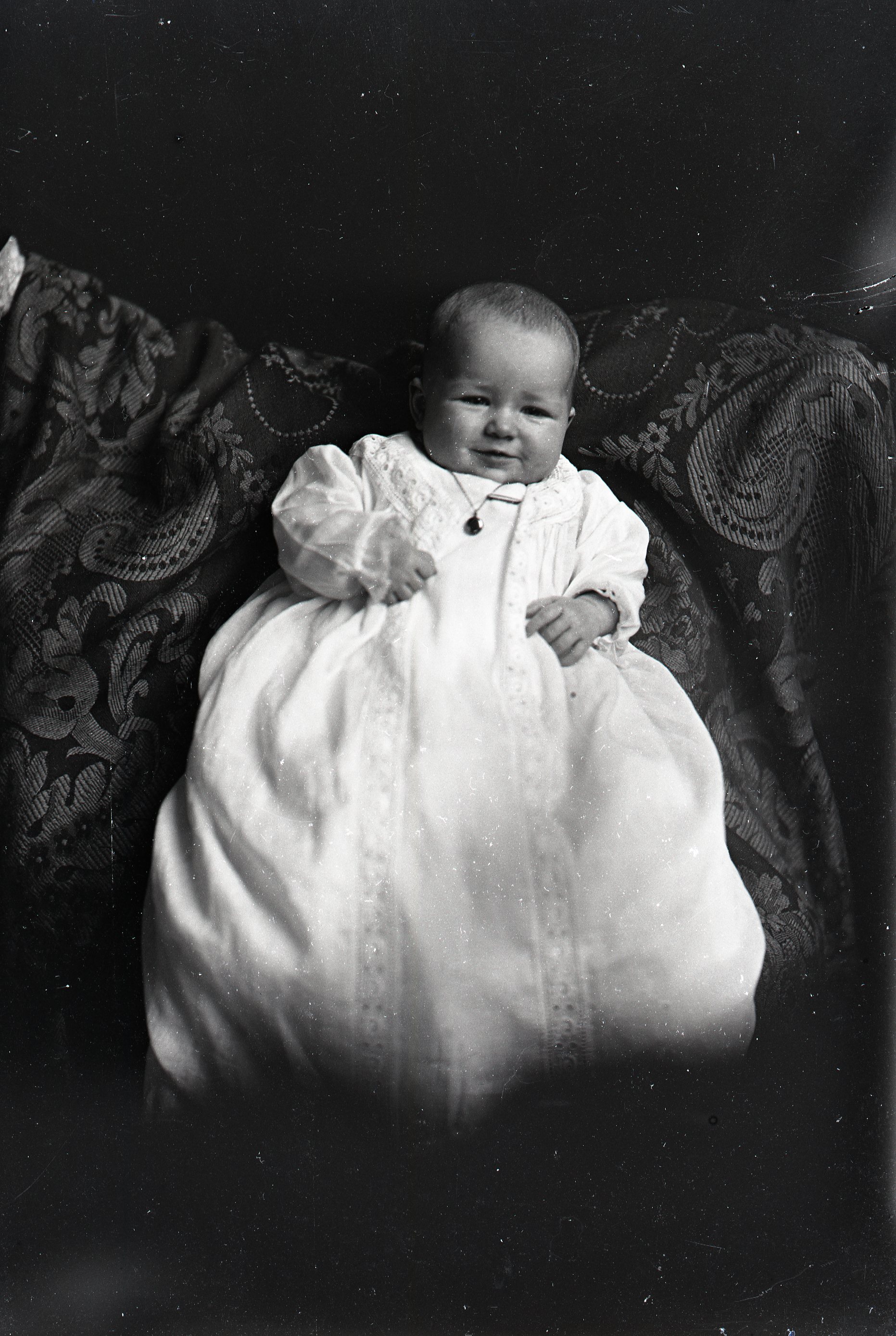 Infant in white gown