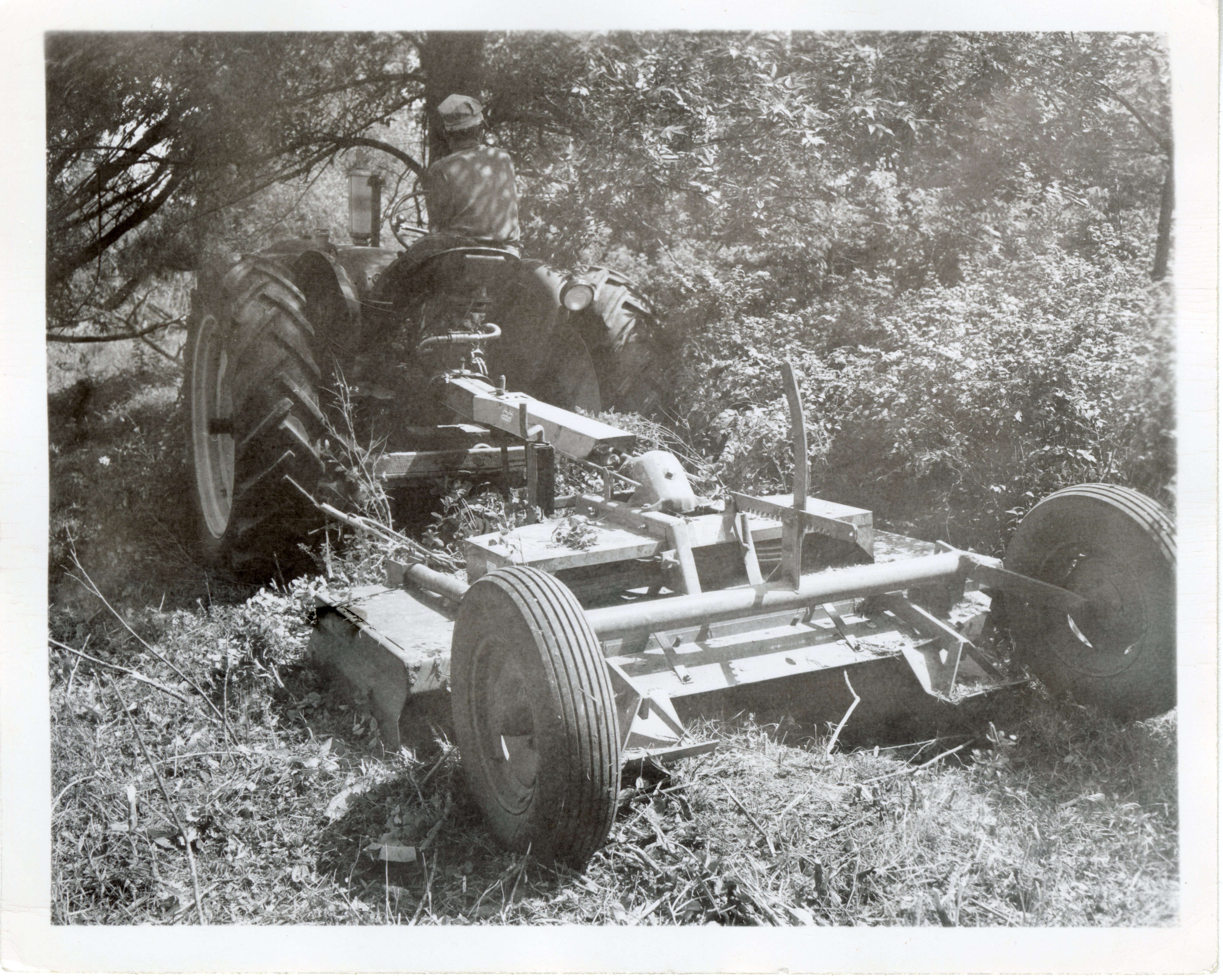 Unidentified Man on Tractor Mower Mows Lawn