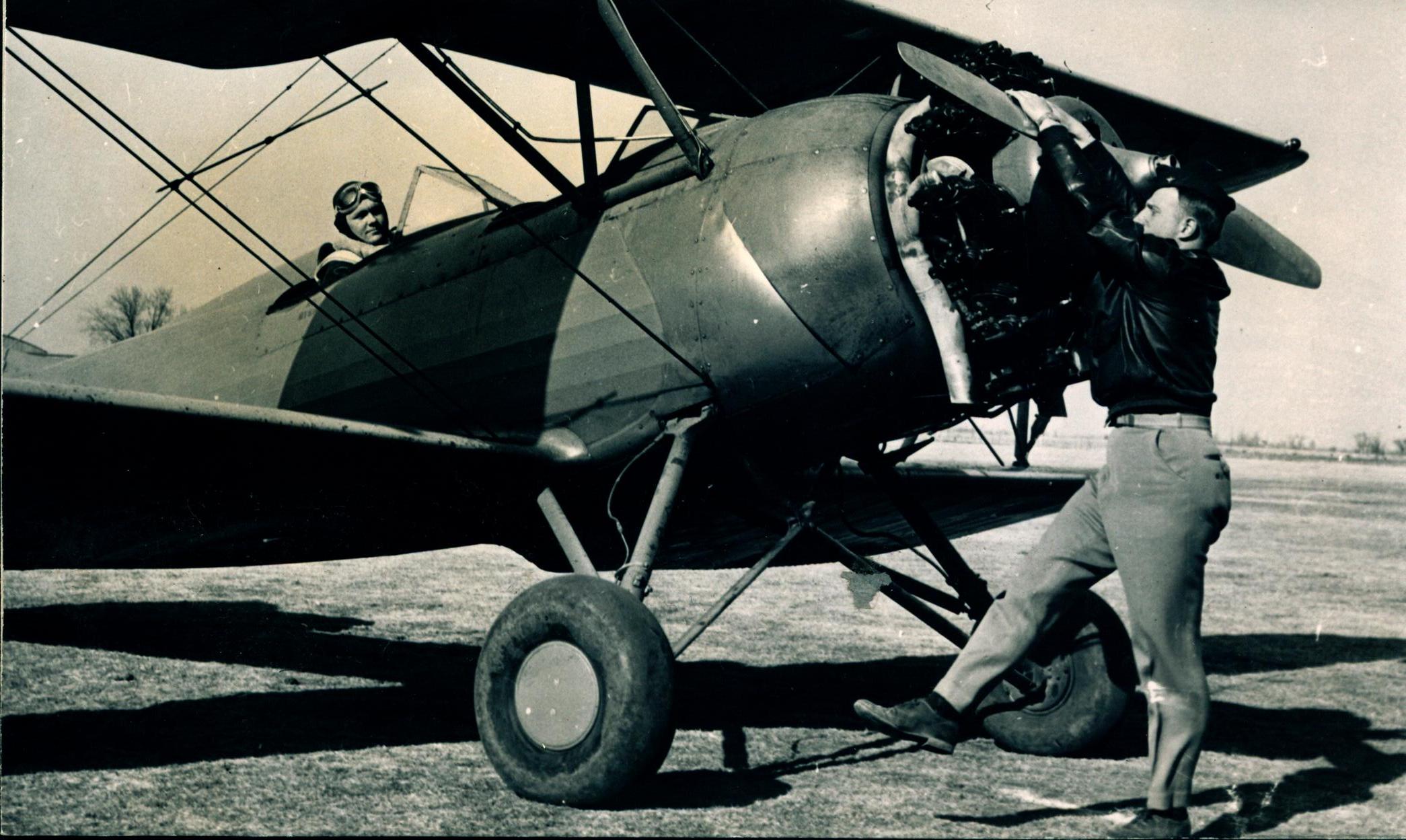 0011_Norman Van Grop, Flight Instructor Spinning the Propellor
