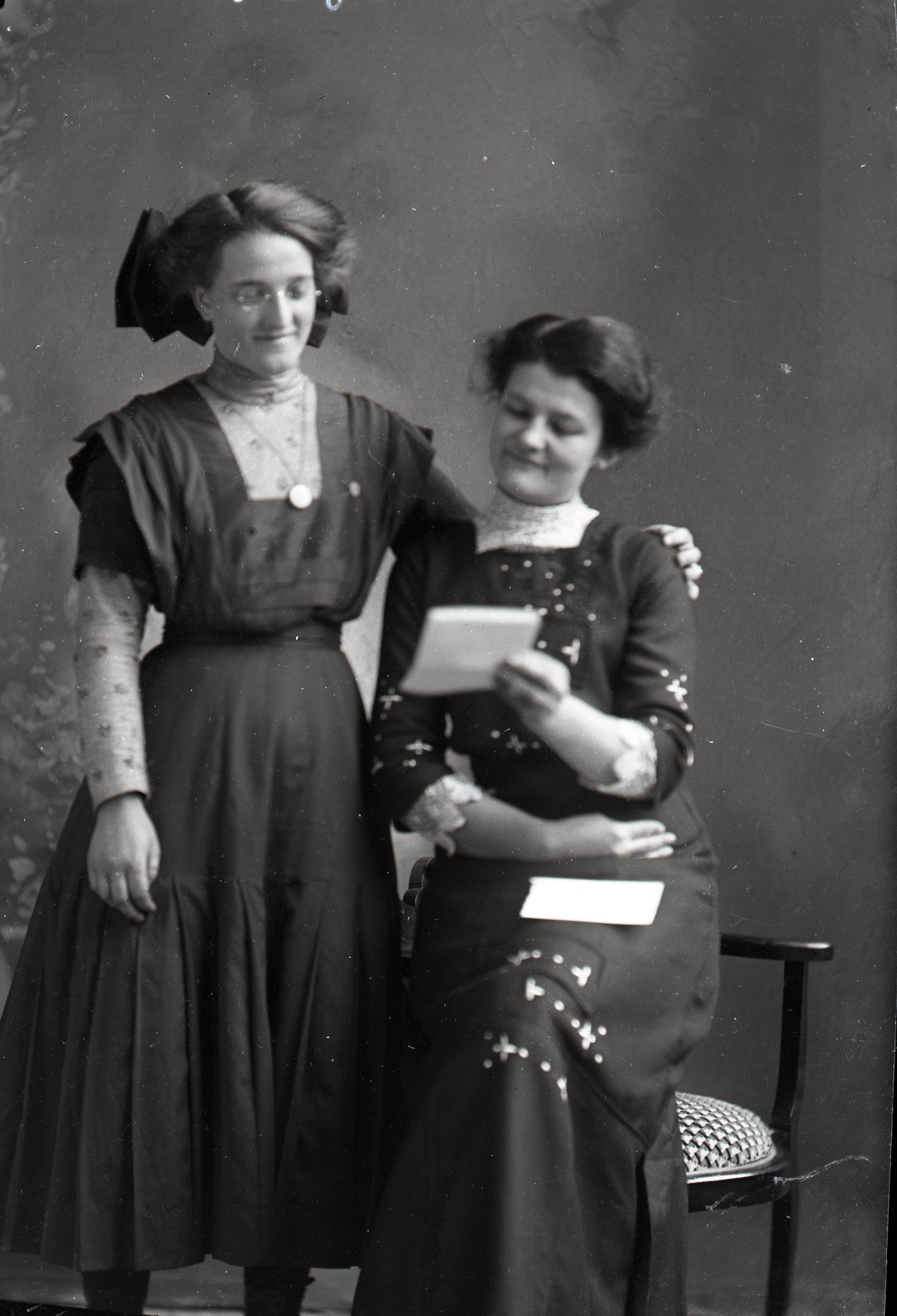 Two women reading a letter