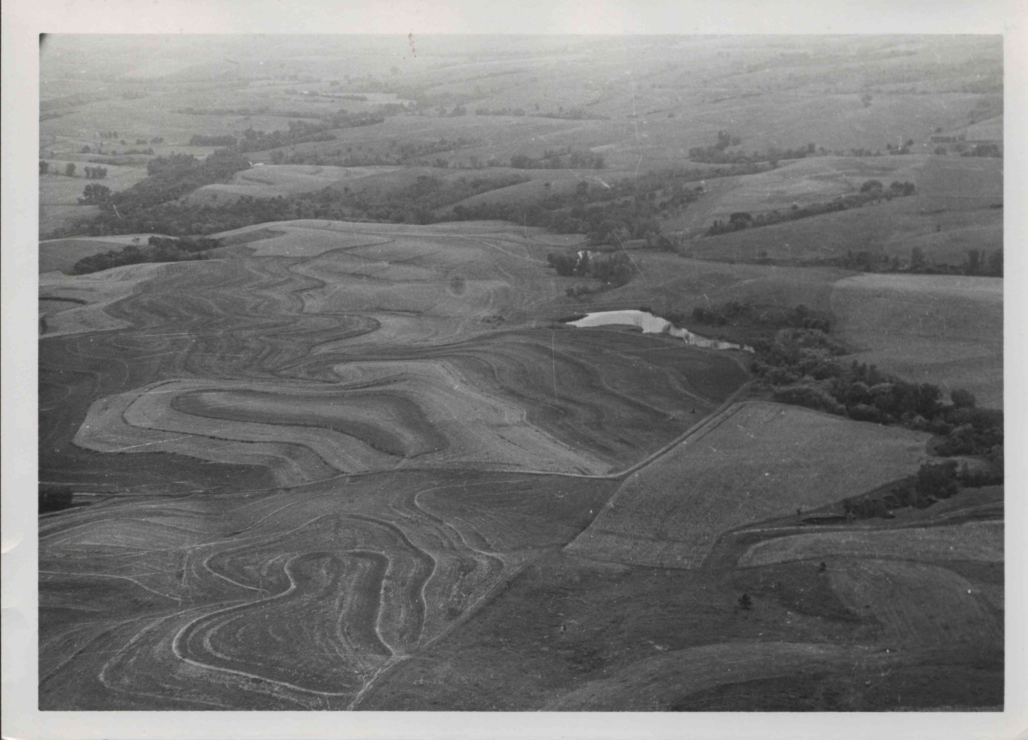 View of contoured farmland with pond in Plymouth County, Iowa