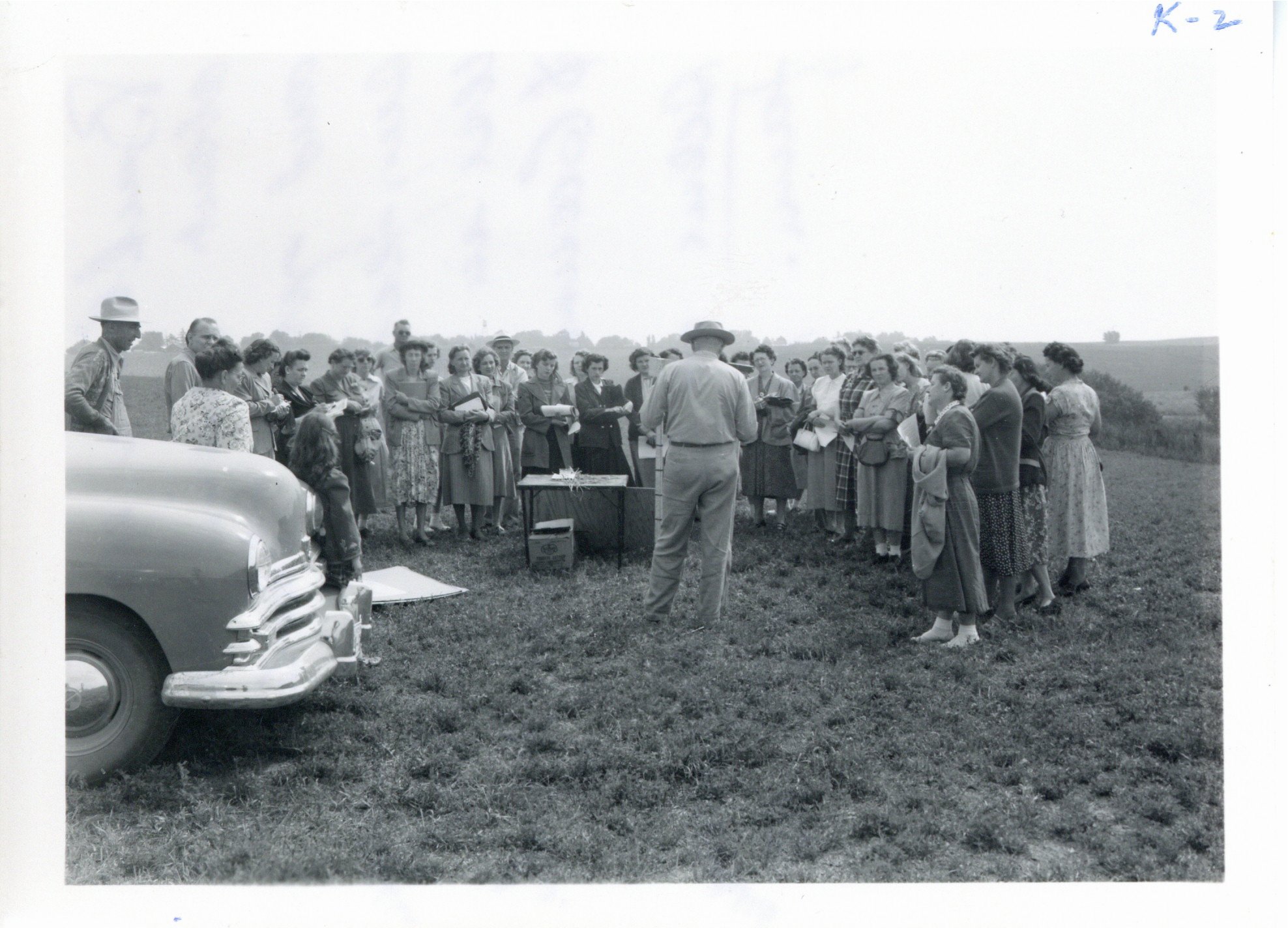 Harlon Backhaus presenting to teachers on V.W. farm, 1950