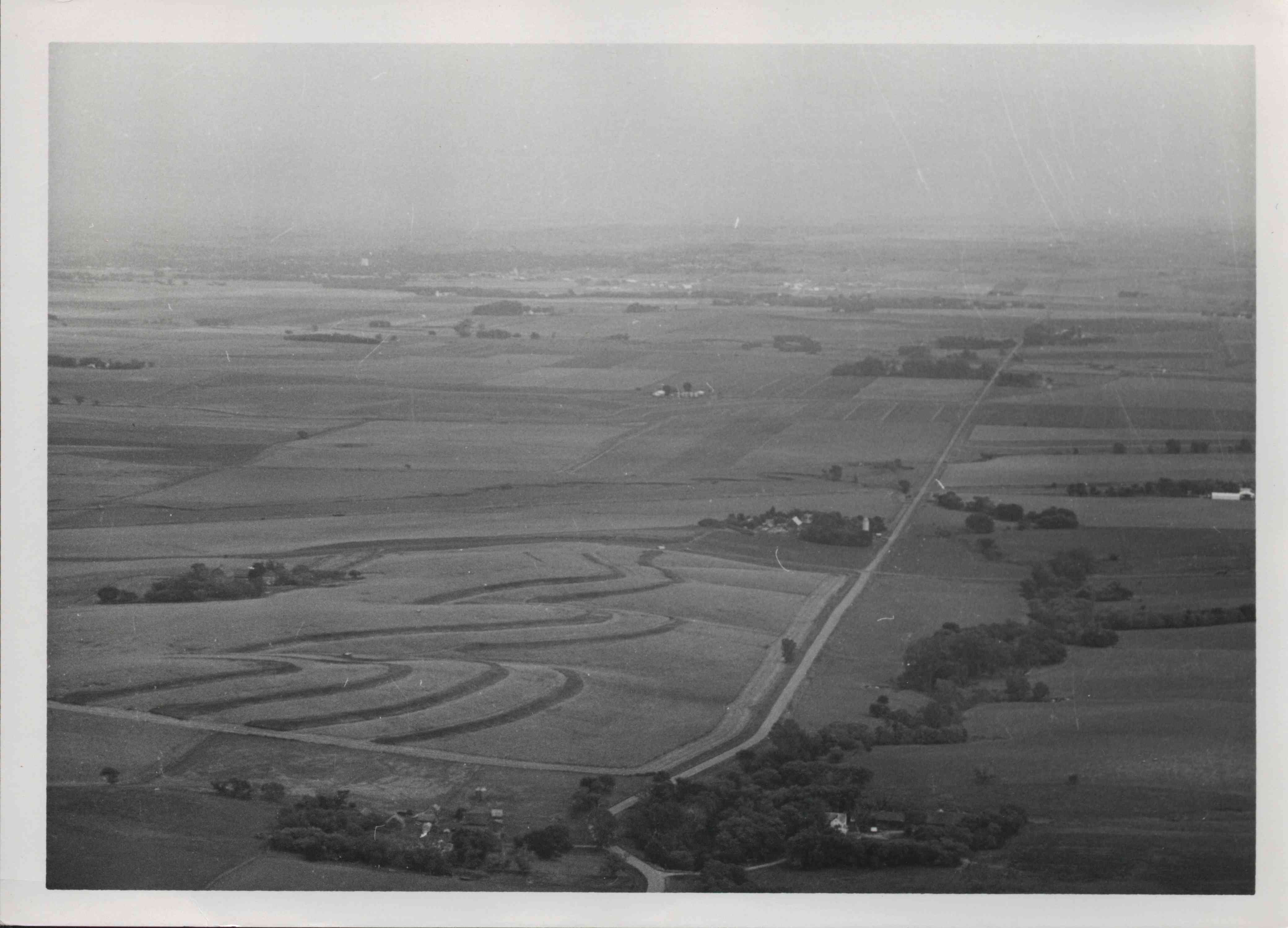Unidentified contoured farmland with scattered trees