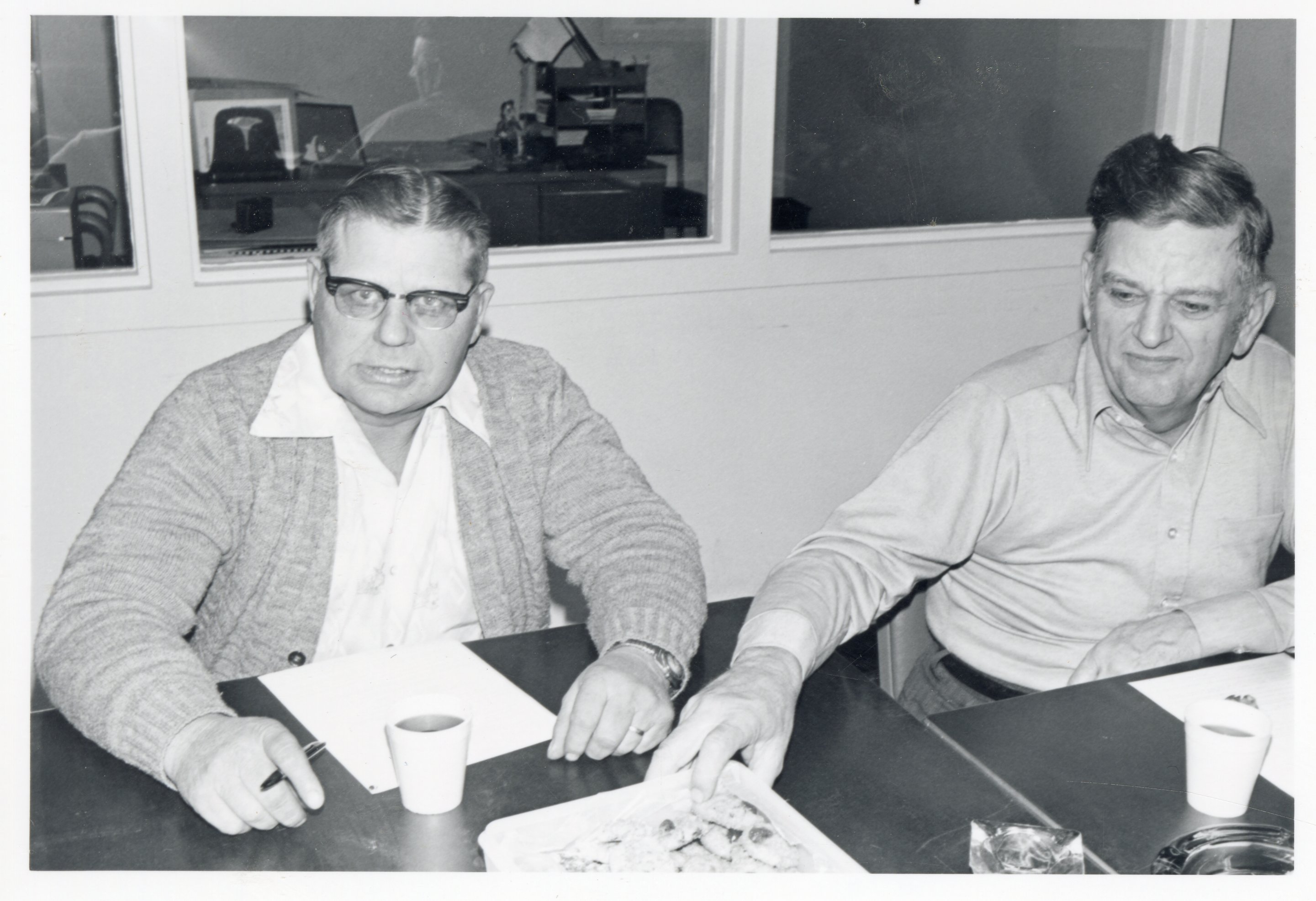 1970s Commissioners Joe Beckman and Dwight Stucker sit at a table during a meeting